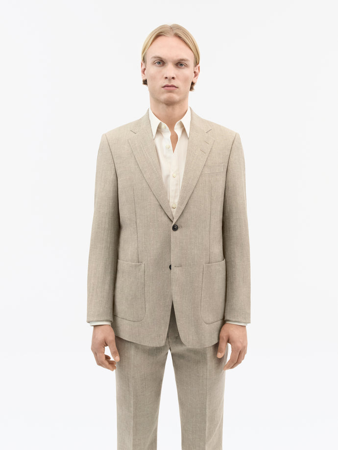 Side view of TIGER OF SWEDEN Justin blazer in Pale Sand for warm-weather styling from eightywingold