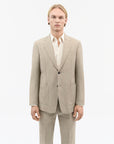 Side view of TIGER OF SWEDEN Justin blazer in Pale Sand for warm-weather styling from eightywingold