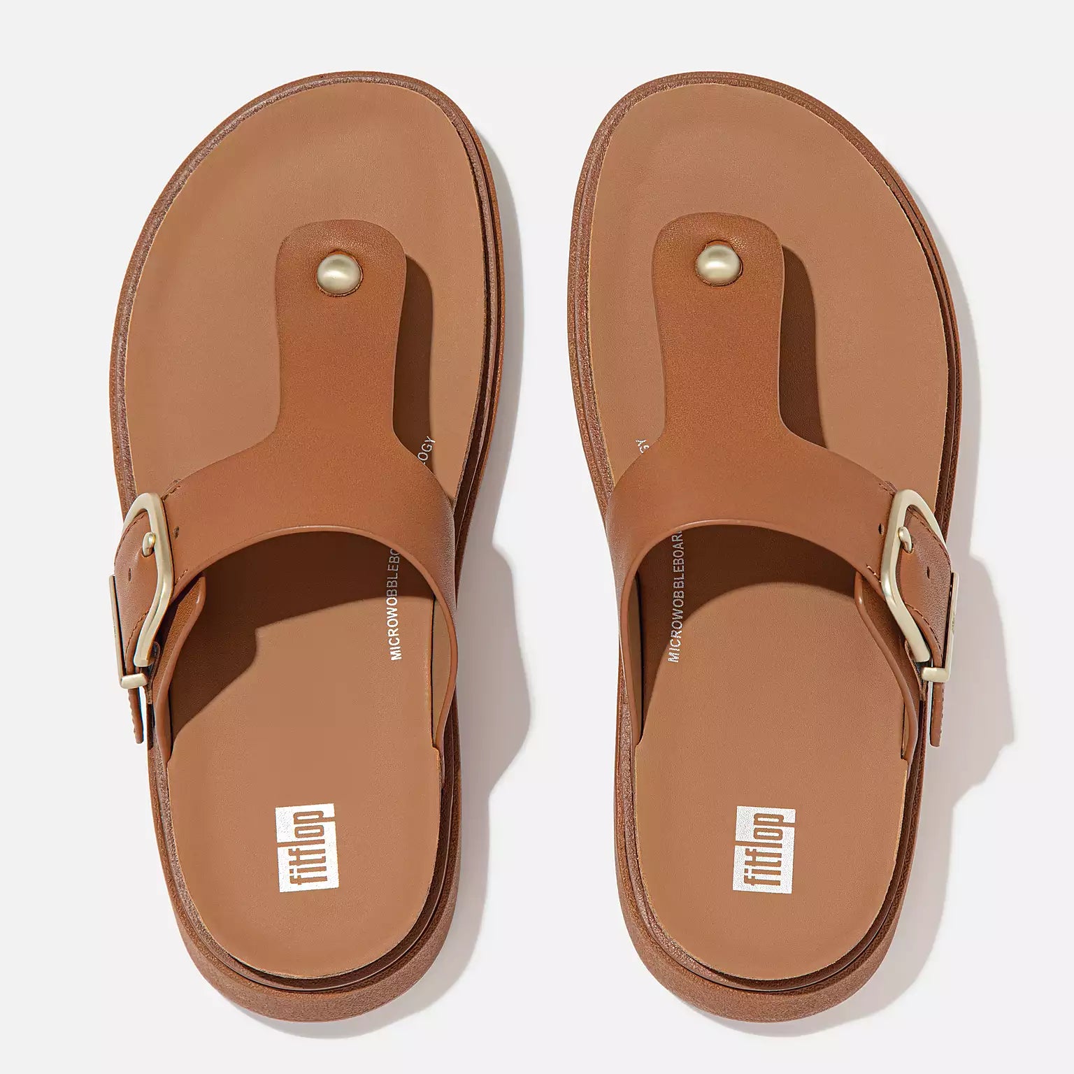 Light Tan FitFlop HE7 592 sandals featuring luxe leather T-bar design, wide fit, recycled metal accents, and APMA-approved comfort technology.
