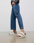 Side profile of FITFLOP two-strap sandals in Urban White in Canada with cork-accented midsole and APMA-approved comfort