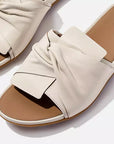 Elegant FITFLOP slides in Canada in Paris Beige featuring sculptural leather bow and ergonomic support