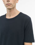 Close-up of TIGER OF SWEDEN chest logo on Olaf L linen blend t-shirt in Light Ink from eightywingold