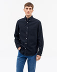 Men’s casual-fit Bjorn button-down shirt in 100% cotton, featuring a larger collar, exposed placket, rounded chest pocket, and refined tailoring details. A clean, versatile everyday shirt.