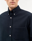 Men’s casual-fit Bjorn button-down shirt in 100% cotton, featuring a larger collar, exposed placket, rounded chest pocket, and refined tailoring details. A clean, versatile everyday shirt.