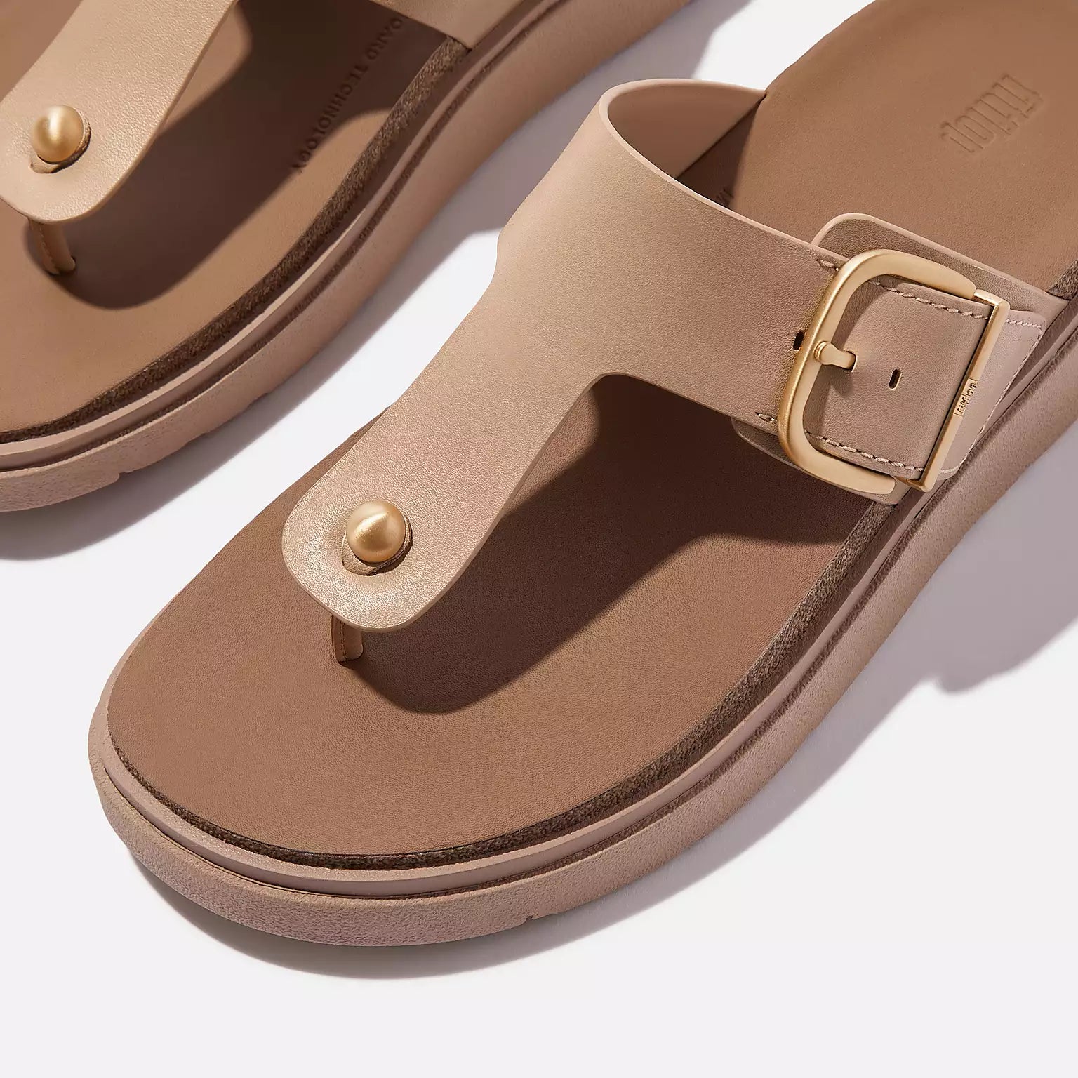 HE7 Fitflop – luxe leather T-bar sandals with domed stud, wide fit, cushioned Microwobbleboard™ sole, and brushed-metal buckle for adjustable comfort.