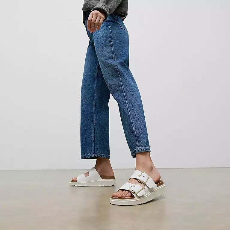 Side profile of FITFLOP two-strap sandals in Urban White in Canada with cork-accented midsole and APMA-approved comfort
