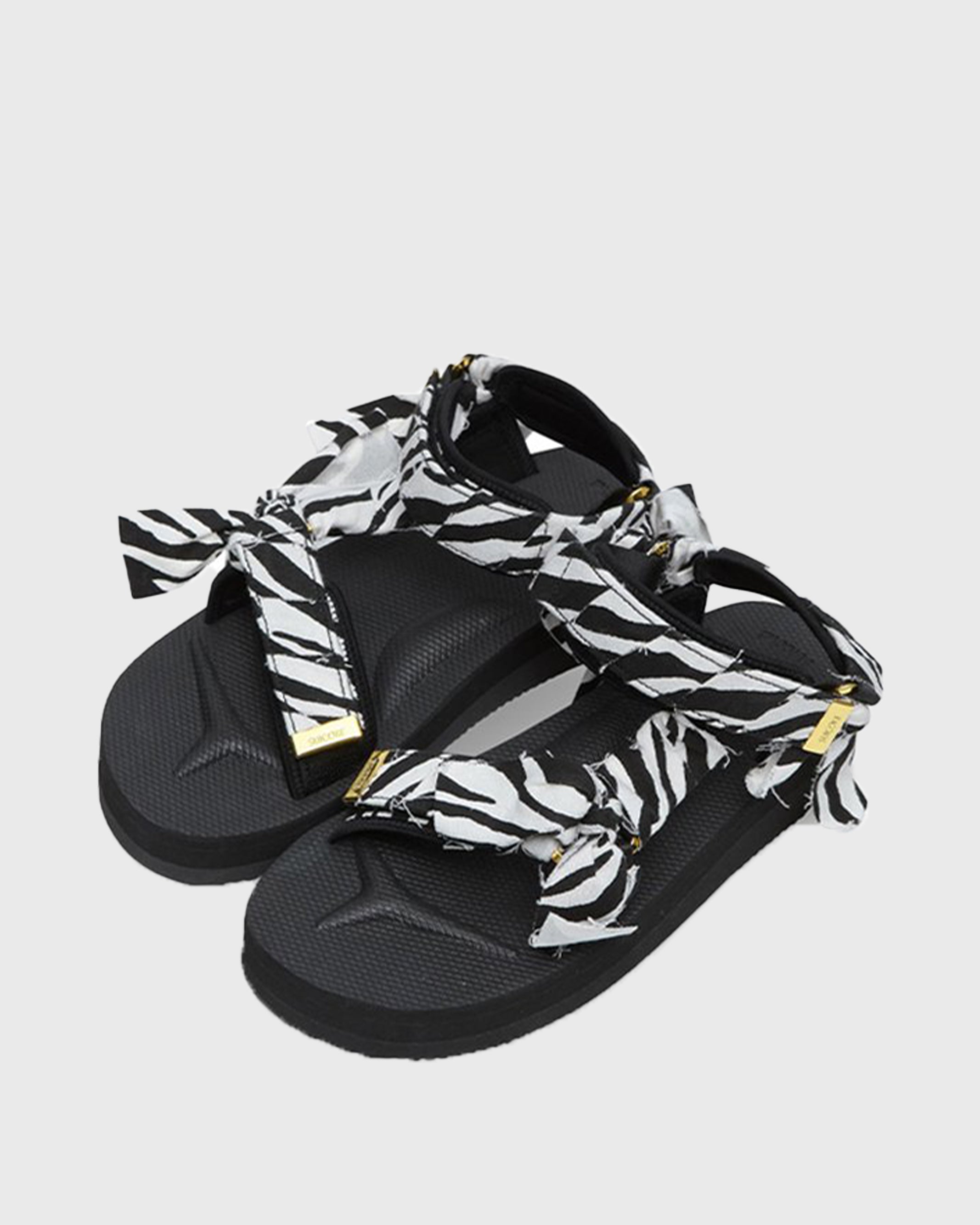 SUICOKE Depa-Fbcpocab-A black platform sandal with zebra printed straps + gold hardware logo tips. From SUICOKE SS21 collection.