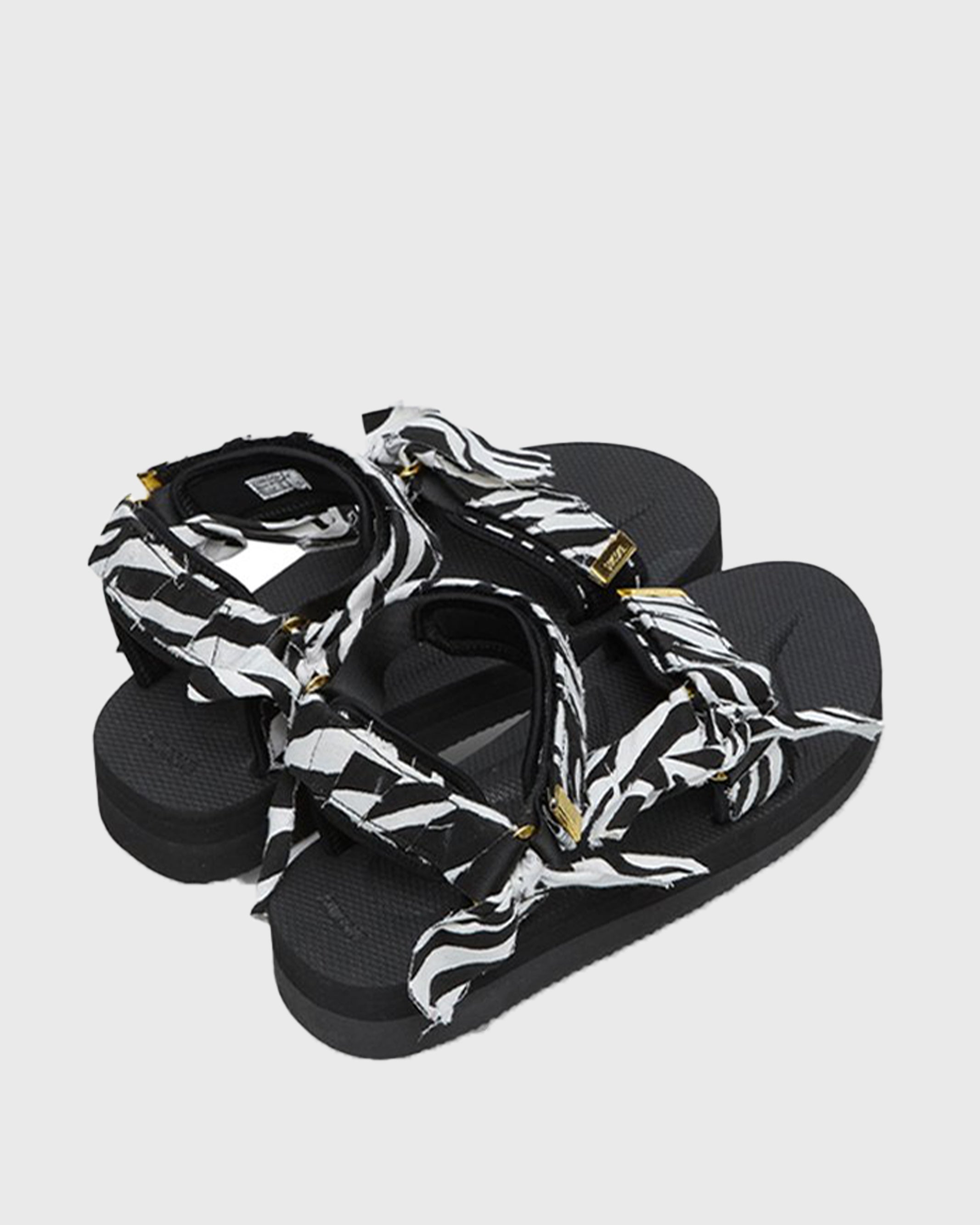 SUICOKE Depa-Fbcpocab-A black platform sandal with zebra printed straps + gold hardware logo tips. From SUICOKE SS21 collection.