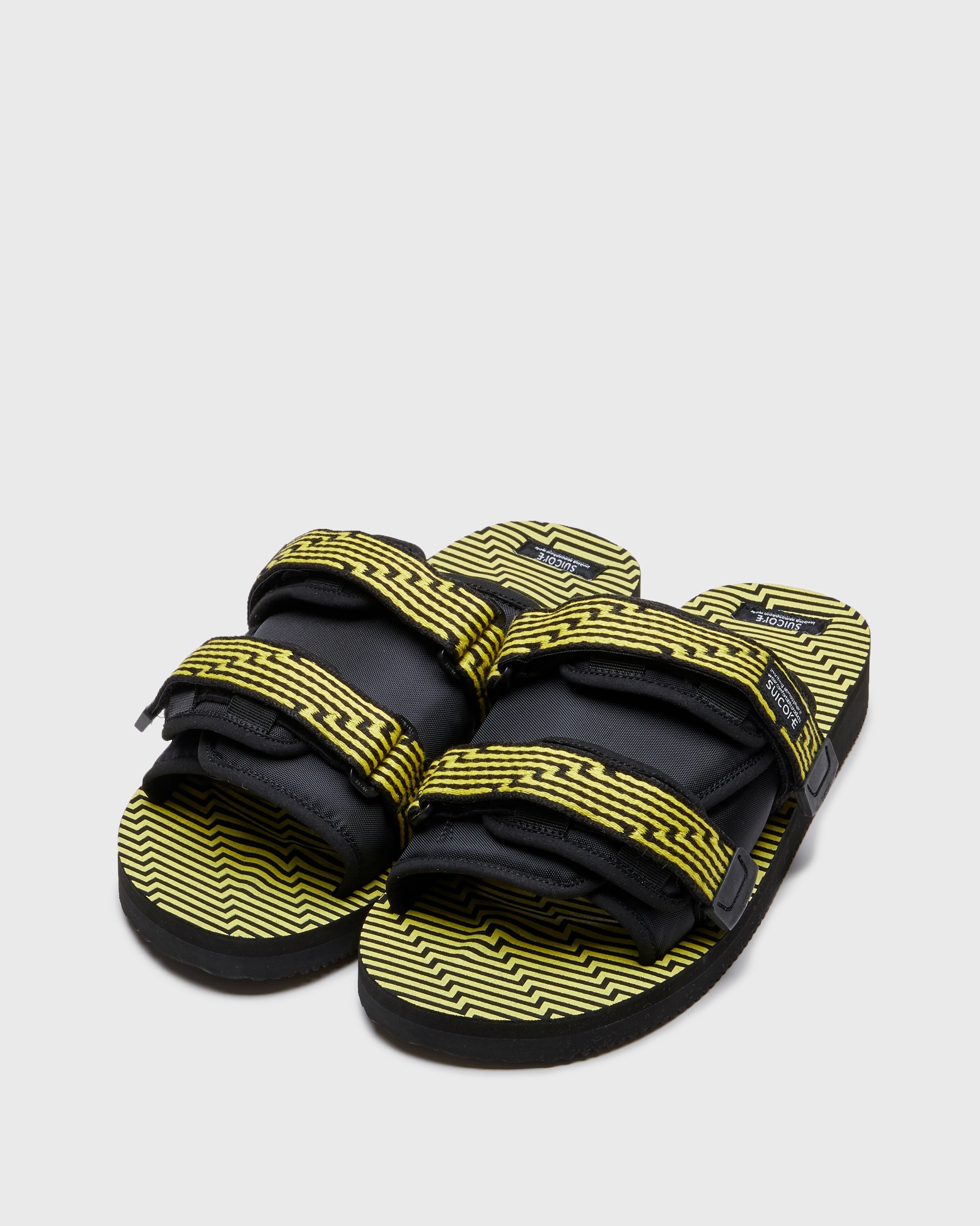 SUICOKE MOTO-JC01 slides with black & yellow nylon and synthetic material  upper, black & yellow midsole and sole, straps and logo patch. From Spring/Summer 2023 collection on SUICOKE Official US & Canada Webstore. OG-056-JC01 BLACK X YELLOW