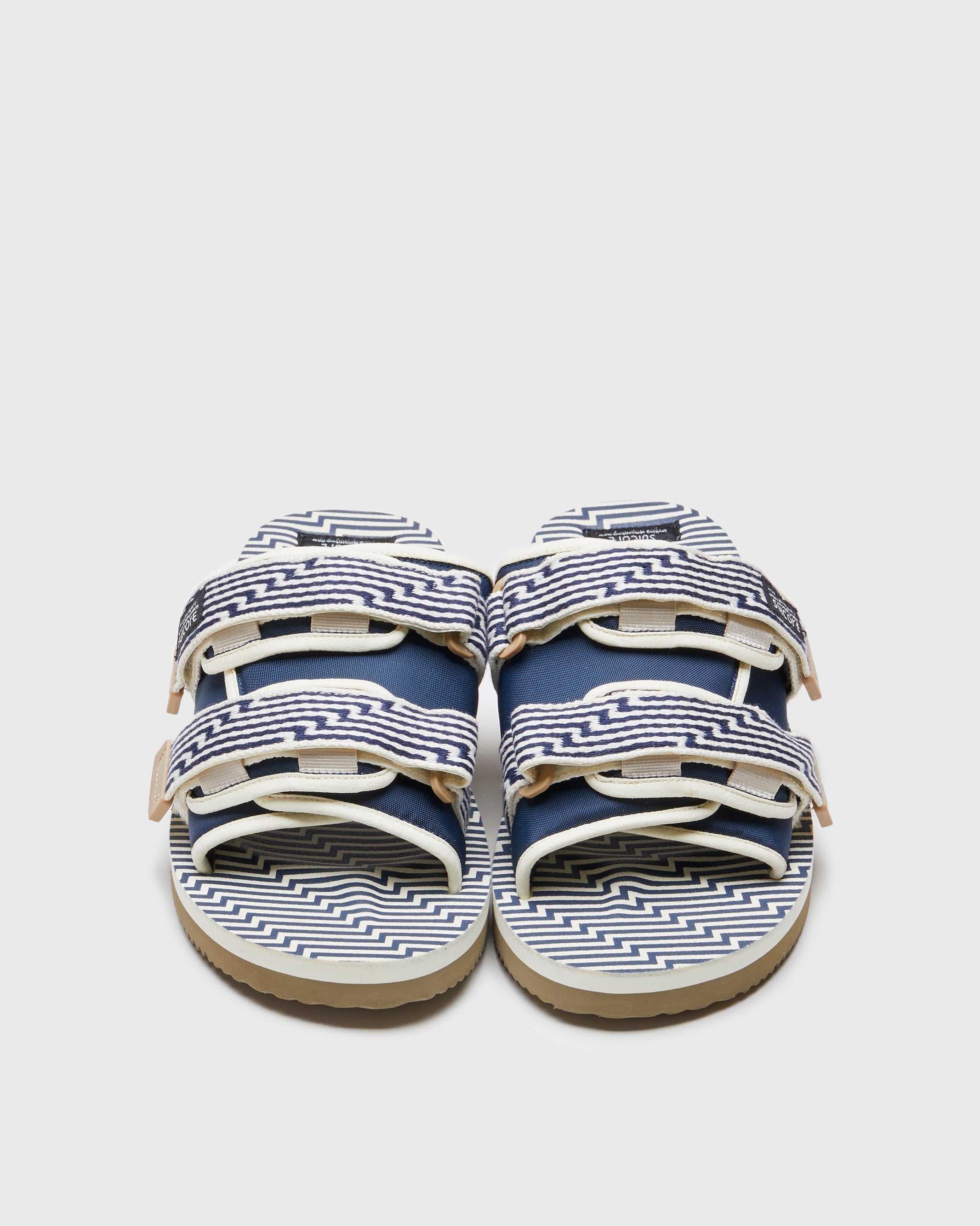 SUICOKE MOTO-JC01 slides with ivory & navy nylon upper, ivory & navy midsole and sole, strap and logo patch. From Spring/Summer 2023 collection on SUICOKE Official US & Canada Webstore. OG-056-JC01 IVORY X NAVY