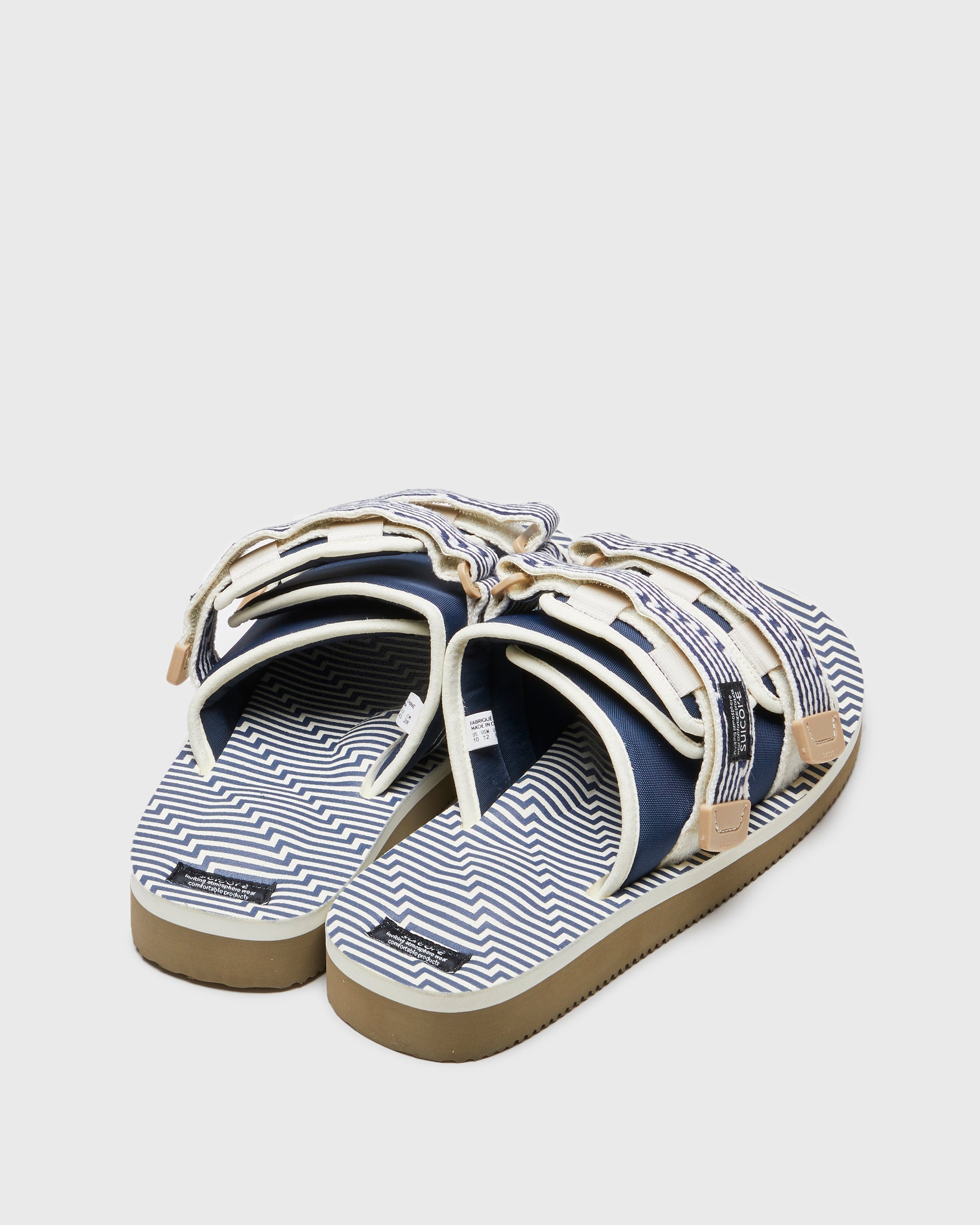 SUICOKE MOTO-JC01 slides with ivory & navy nylon upper, ivory & navy midsole and sole, strap and logo patch. From Spring/Summer 2023 collection on SUICOKE Official US & Canada Webstore. OG-056-JC01 IVORY X NAVY