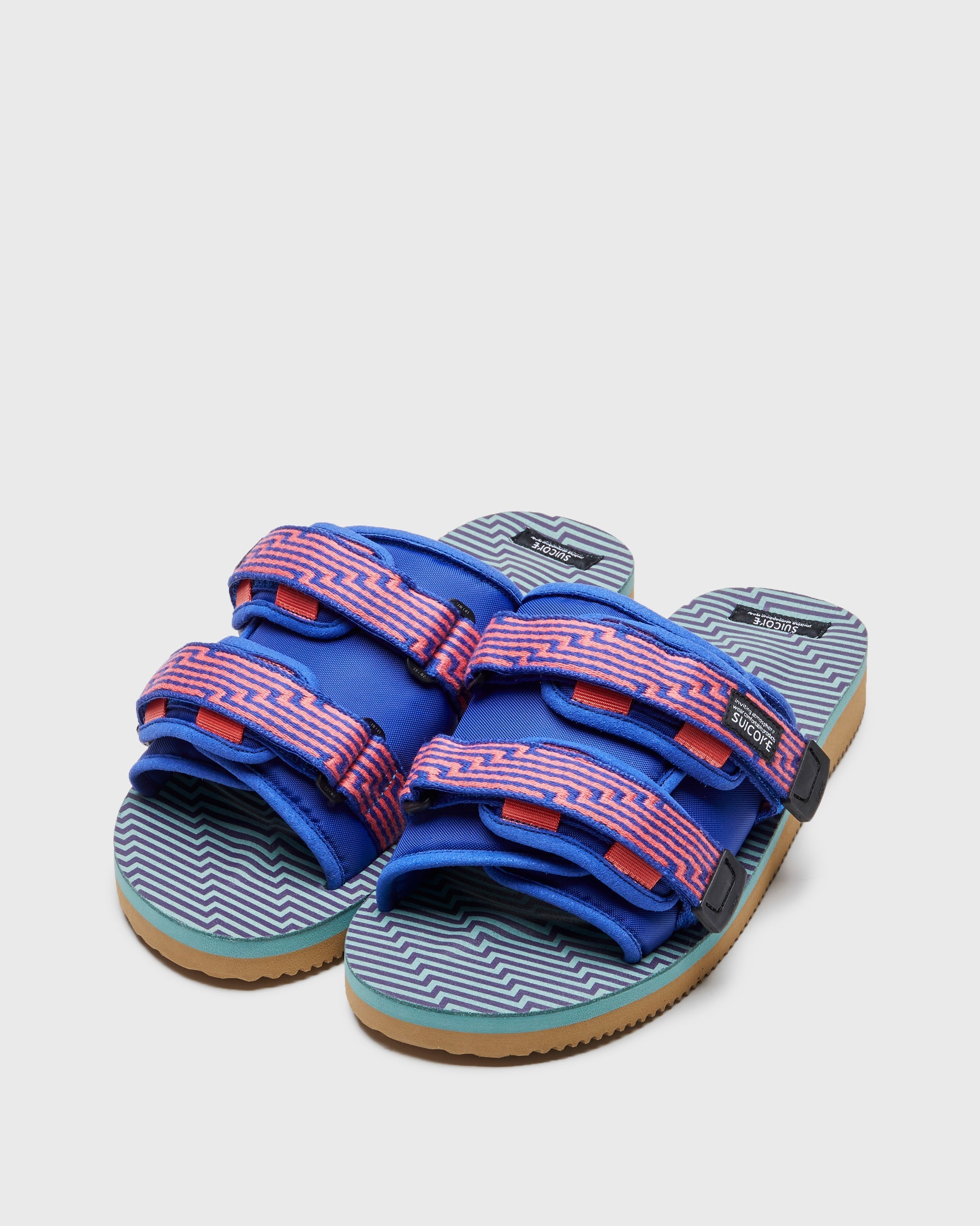 SUICOKE MOTO-JC01 slides with orange & blue nylon upper, orange & blue midsole and sole, strap and logo patch. From Spring/Summer 2023 collection on SUICOKE Official US & Canada Webstore. OG-056-JC01 ORANGE X BLUE