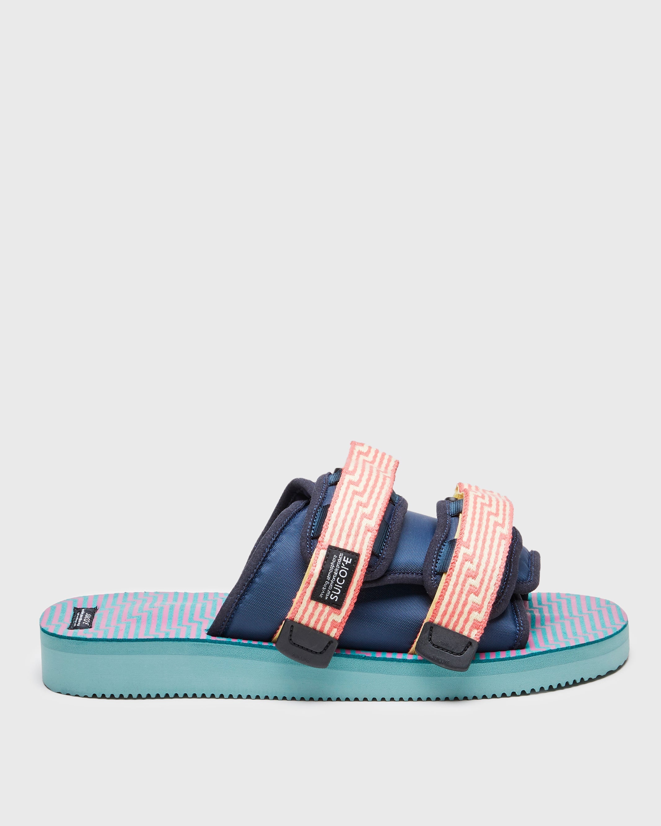 SUICOKE MOTO-JC01 slides with yellow & pink nylon upper, yellow & pink midsole and sole, strap and logo patch. From Spring/Summer 2023 collection on SUICOKE Official US & Canada Webstore. OG-056-JC01 YELLOW X PINK