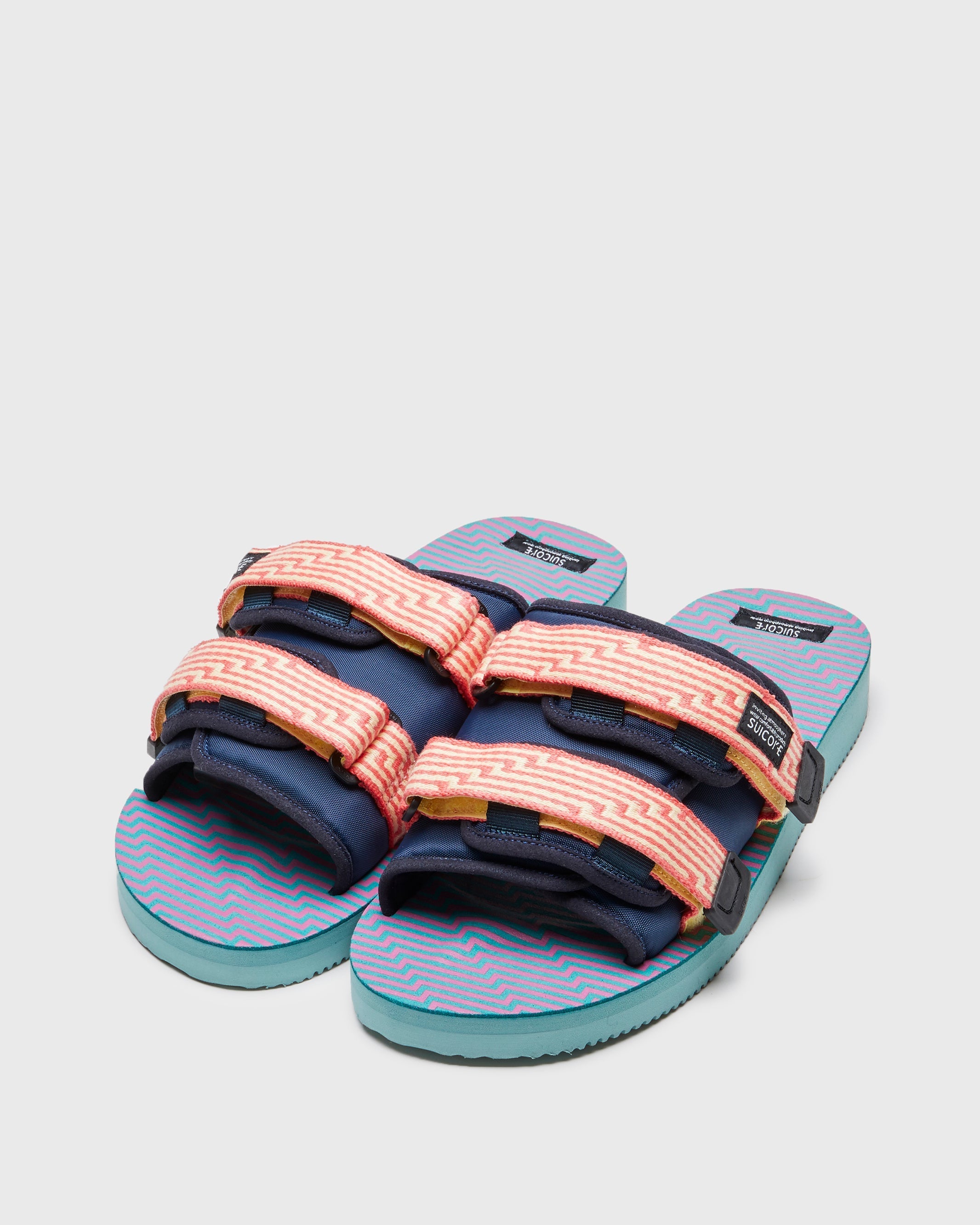 SUICOKE MOTO-JC01 slides with yellow & pink nylon upper, yellow & pink midsole and sole, strap and logo patch. From Spring/Summer 2023 collection on SUICOKE Official US & Canada Webstore. OG-056-JC01 YELLOW X PINK