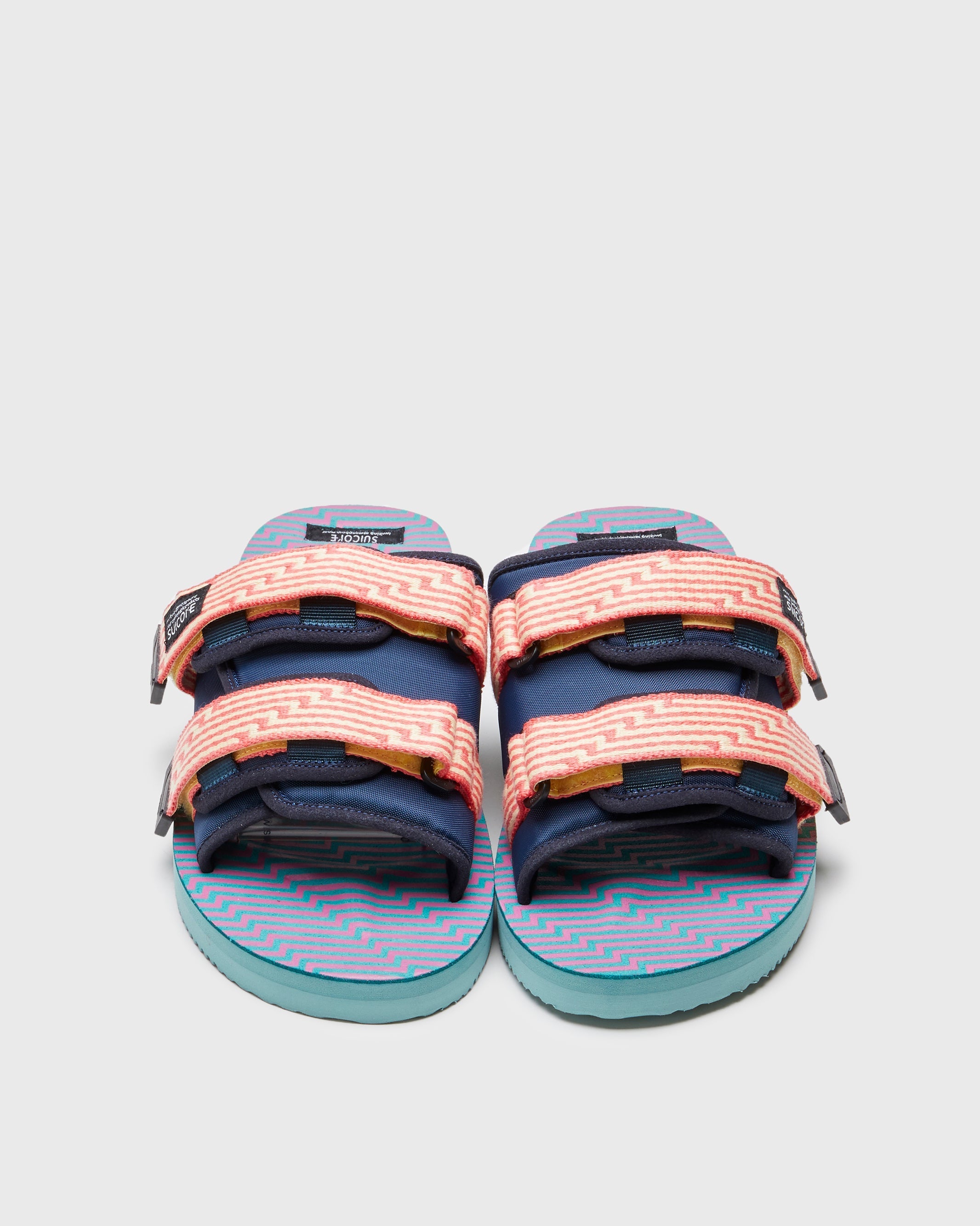 SUICOKE MOTO-JC01 slides with yellow & pink nylon upper, yellow & pink midsole and sole, strap and logo patch. From Spring/Summer 2023 collection on SUICOKE Official US & Canada Webstore. OG-056-JC01 YELLOW X PINK