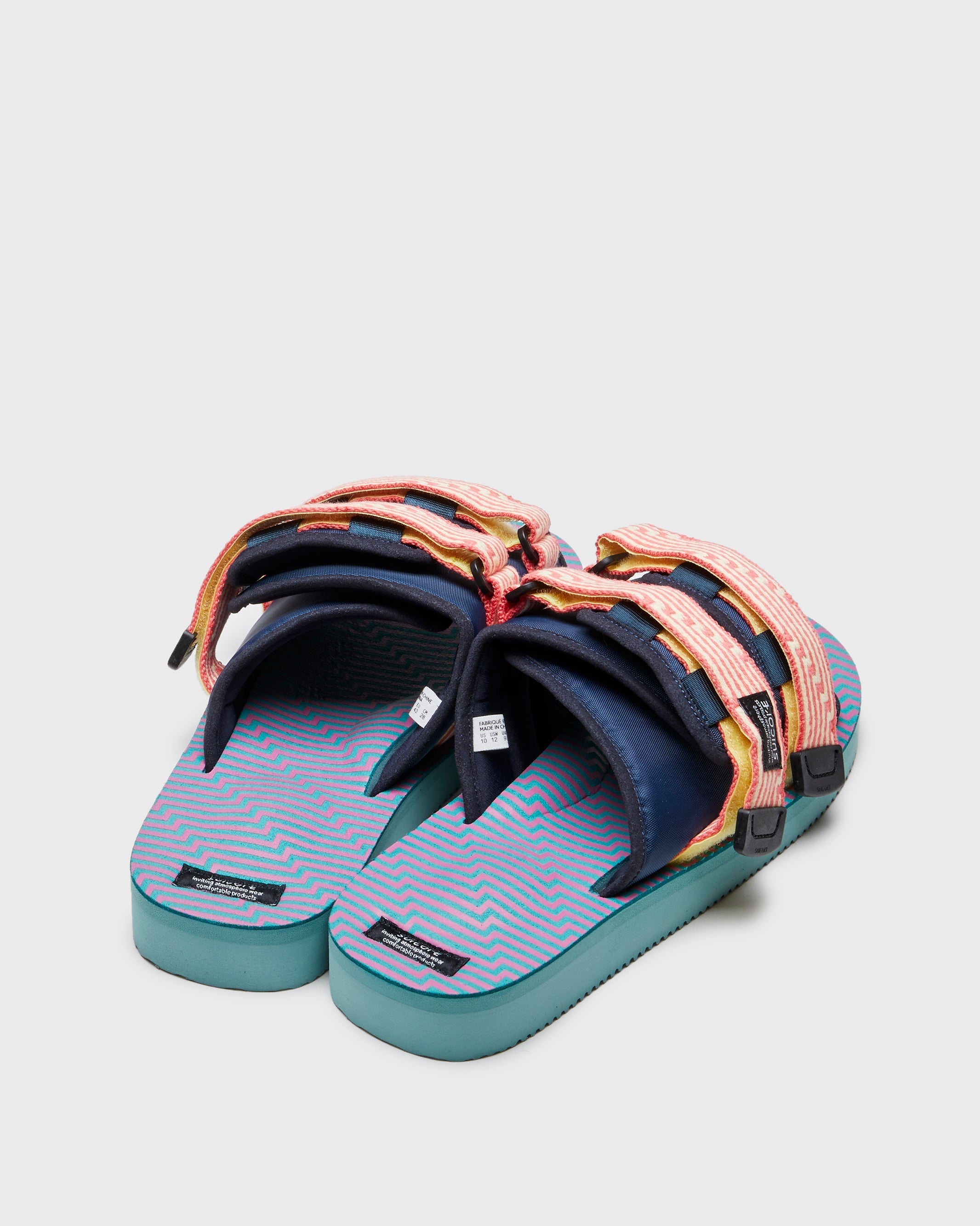 SUICOKE MOTO-JC01 slides with yellow & pink nylon upper, yellow & pink midsole and sole, strap and logo patch. From Spring/Summer 2023 collection on SUICOKE Official US & Canada Webstore. OG-056-JC01 YELLOW X PINK