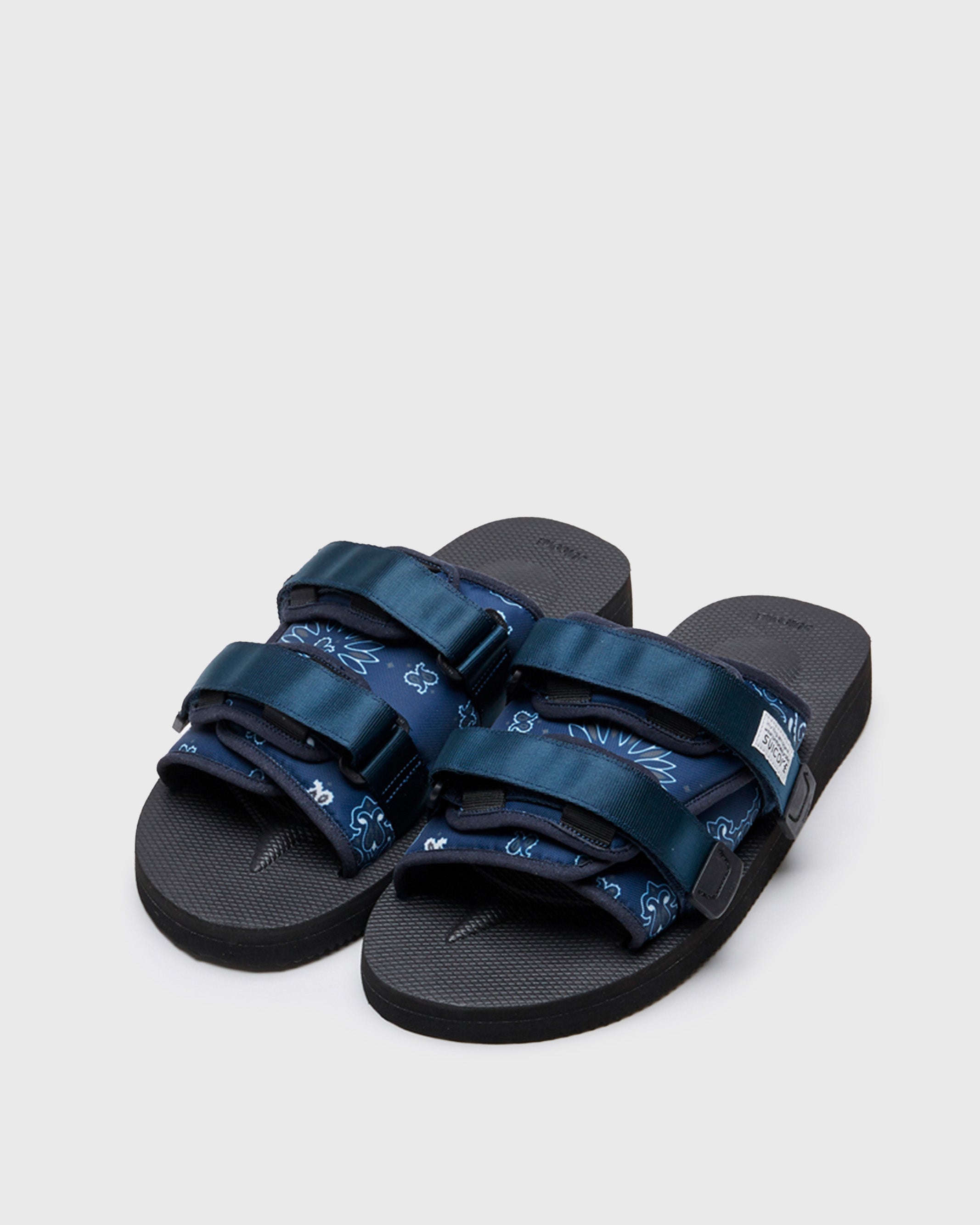 SUICOKE MOTO-Cab-PT02 slides with navy nylon upper, black midsole and sole, straps and logo patch. From Spring/Summer 2022 collection on SUICOKE Official US & Canada Webstore.