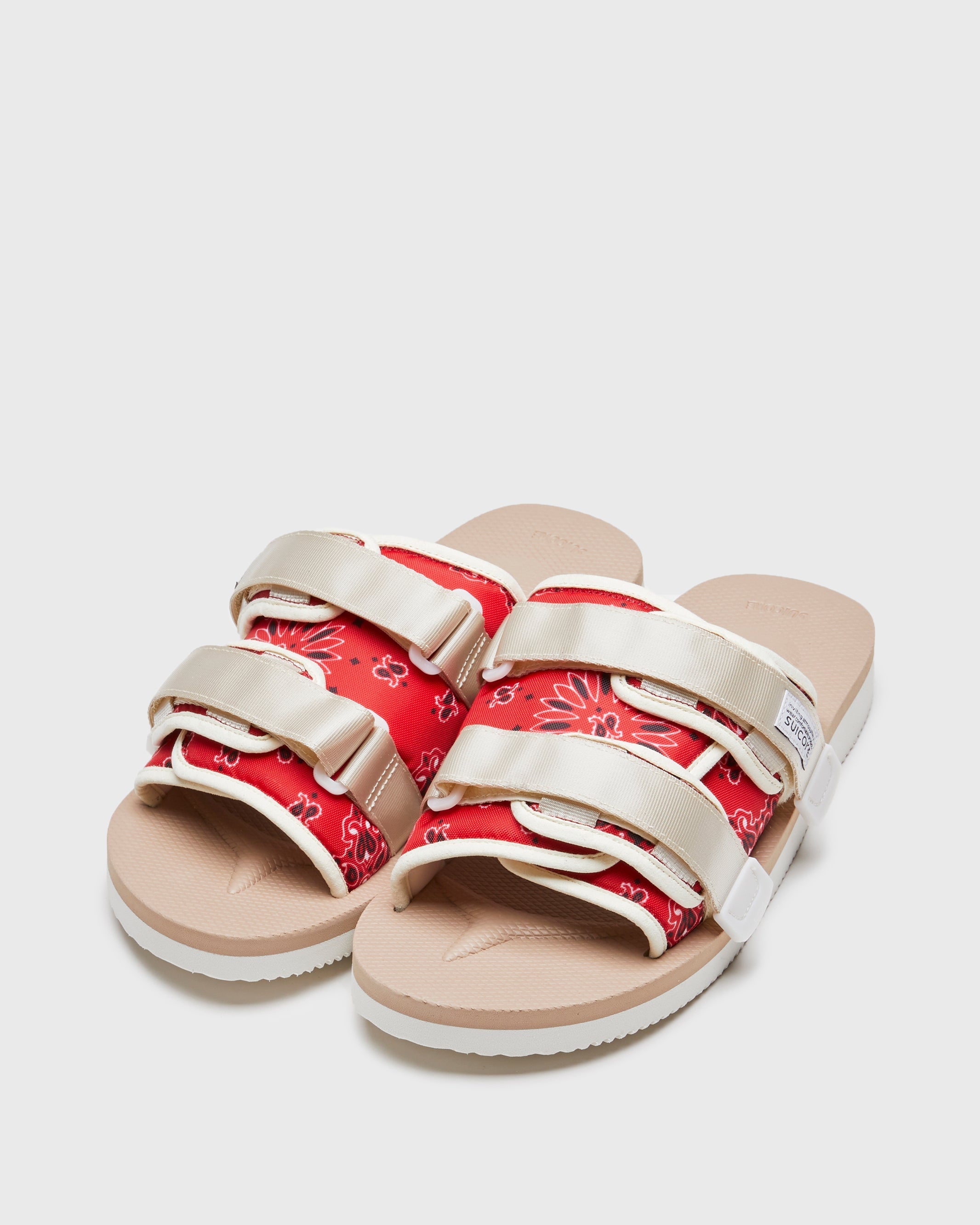 SUICOKE MOTO-Cab-PT05 slides with red & beige nylon upper, red & beige midsole and sole, strap and logo patch. From Spring/Summer 2023 collection on SUICOKE Official US & Canada Webstore. OG-056CAB-PT05 RED X BEIGE