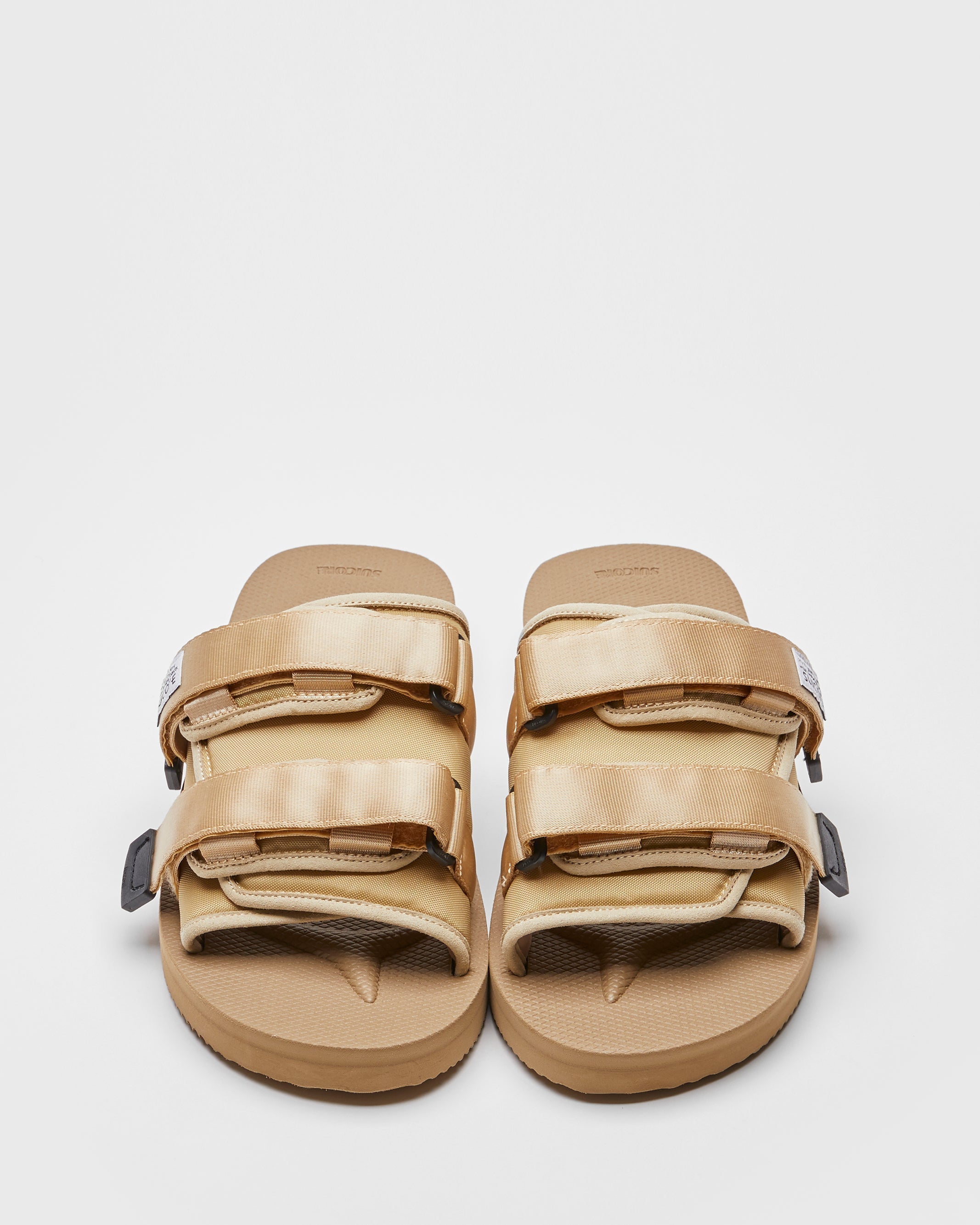 SUICOKE MOTO-Cab slides with beige nylon upper, beige midsole and sole, straps and logo patch. From Spring/Summer 2022 collection on SUICOKE Official US & Canada Webstore.