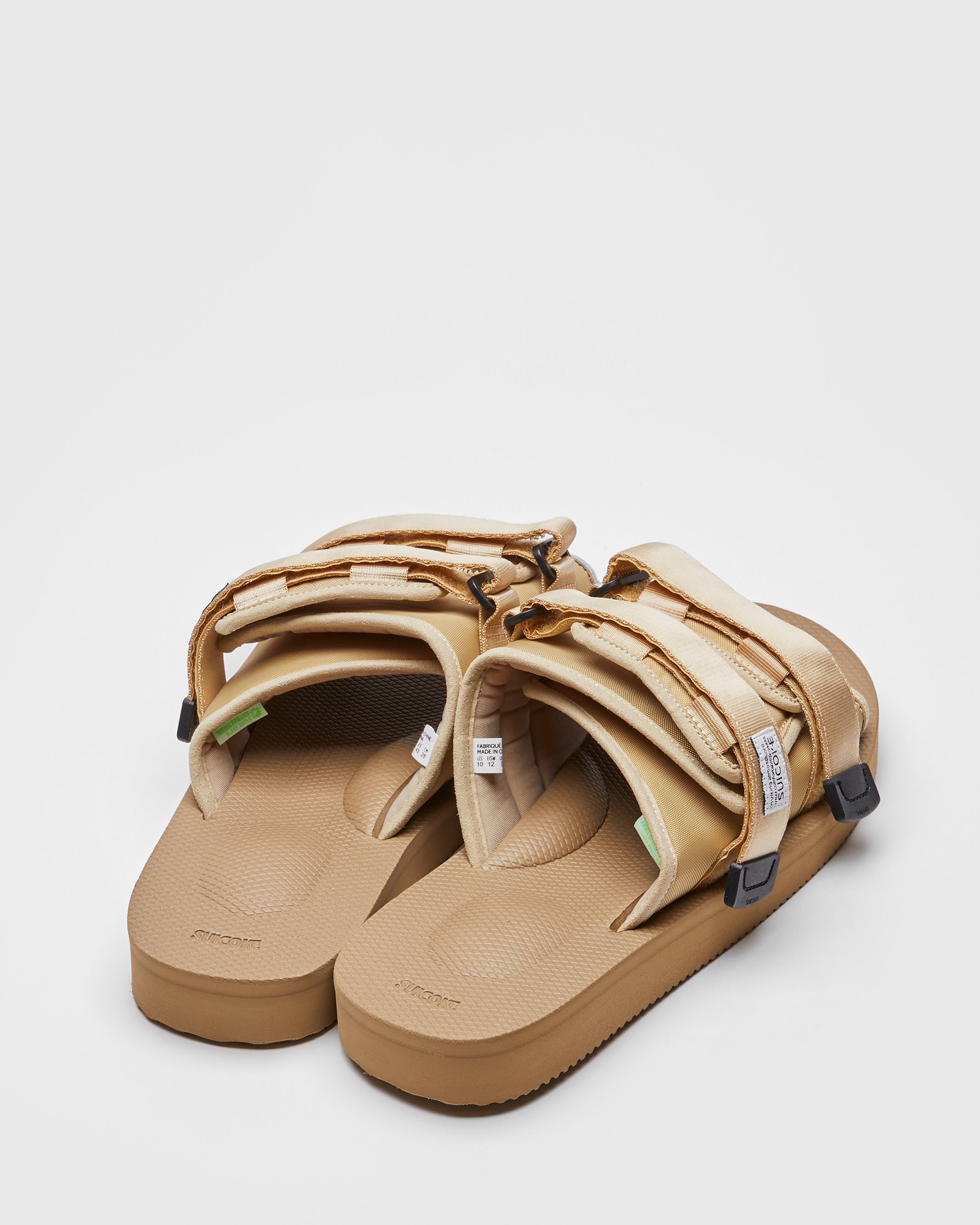 SUICOKE MOTO-Cab slides with beige nylon upper, beige midsole and sole, straps and logo patch. From Spring/Summer 2022 collection on SUICOKE Official US & Canada Webstore.