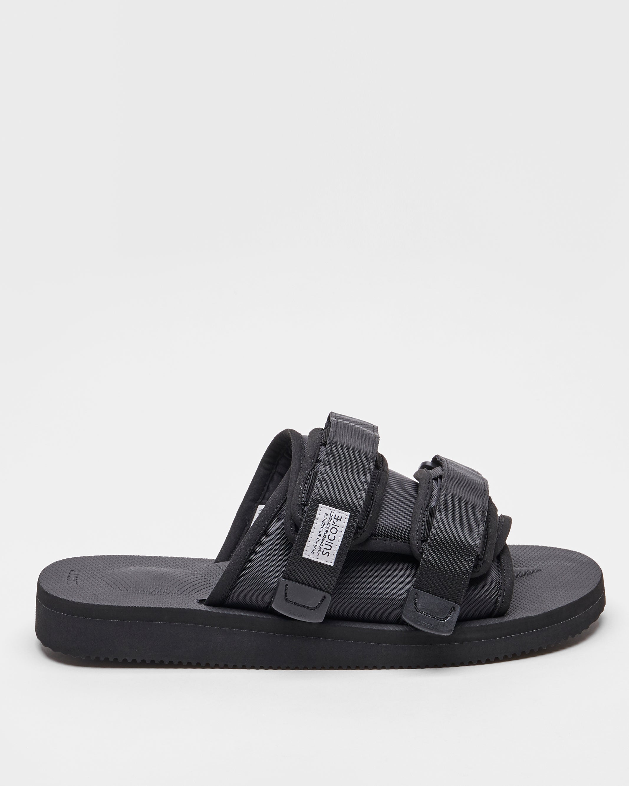 SUICOKE MOTO-Cab slides with black nylon upper, black midsole and sole, straps and logo patch. From Spring/Summer 2022 collection on SUICOKE Official US &amp; Canada Webstore.