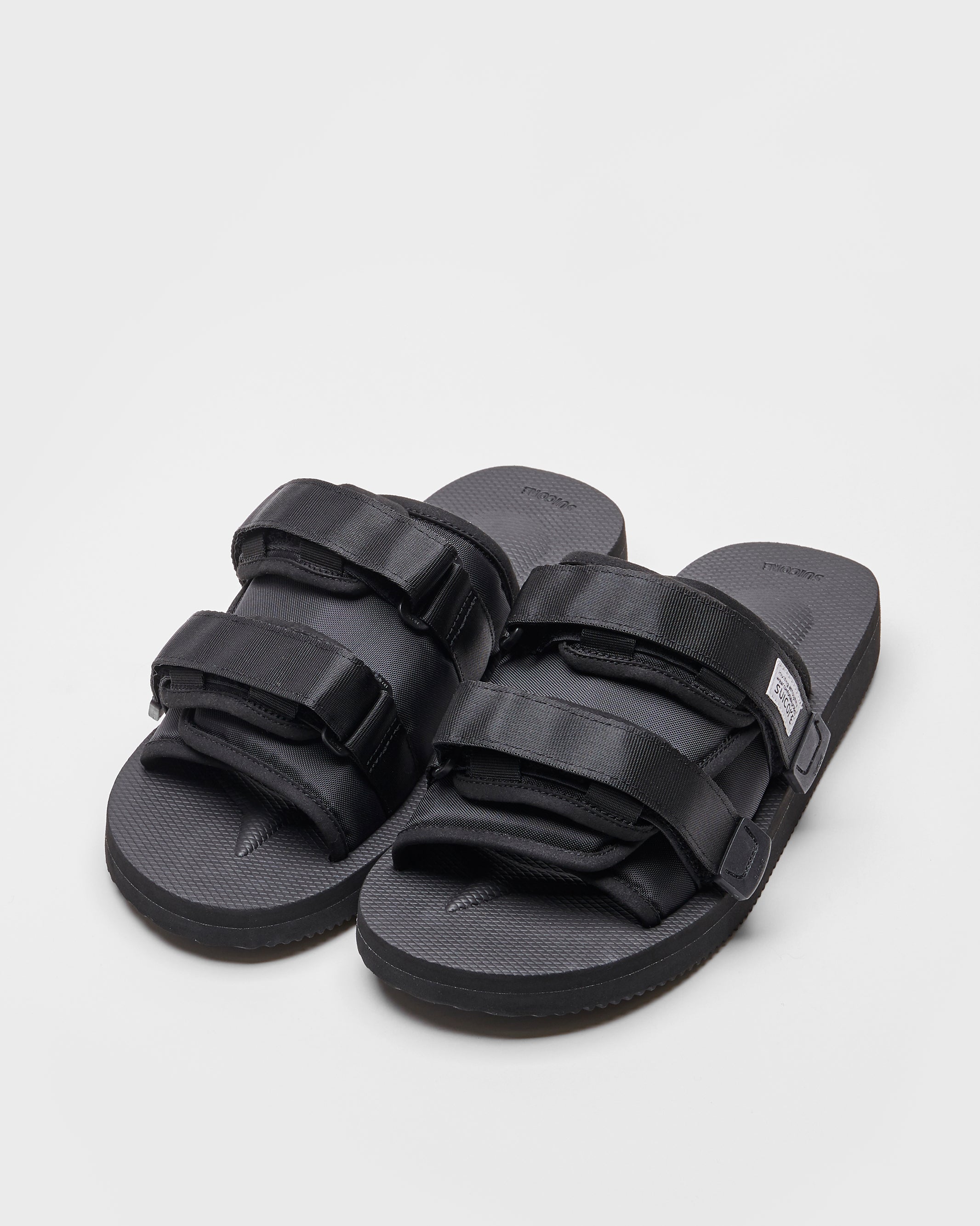 SUICOKE MOTO-Cab slides with black nylon upper, black midsole and sole, straps and logo patch. From Spring/Summer 2022 collection on SUICOKE Official US &amp; Canada Webstore.