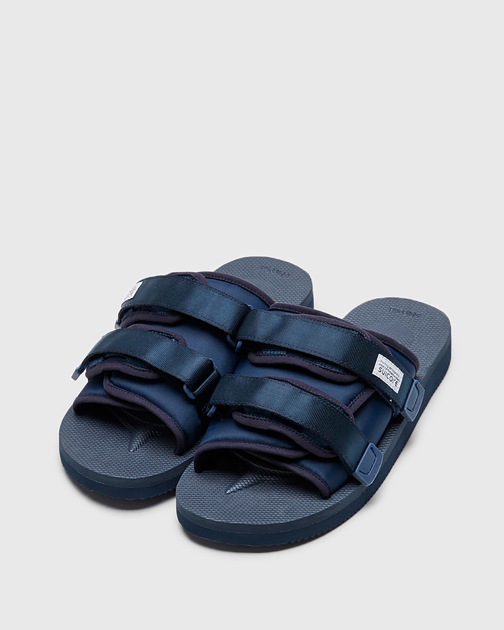 SUICOKE MOTO-Cab slides with navy nylon upper, navy midsole and sole, straps and logo patch. From Spring/Summer 2023 collection on SUICOKE Official US & Canada Webstore. OG-056CAB NAVY