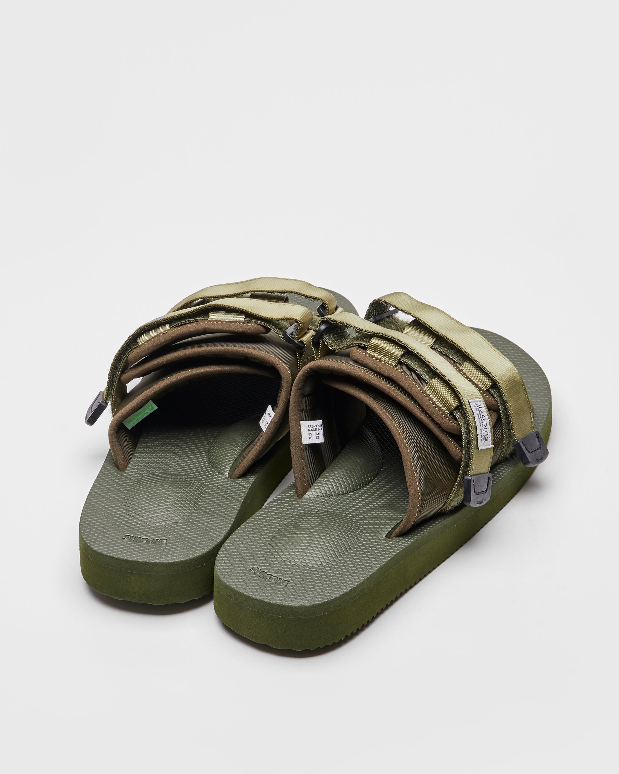 SUICOKE MOTO-Cab slides with olive nylon upper, olive midsole and sole, straps and logo patch. From Spring/Summer 2023 collection on SUICOKE Official US & Canada Webstore. OG-056CAB OLIVE