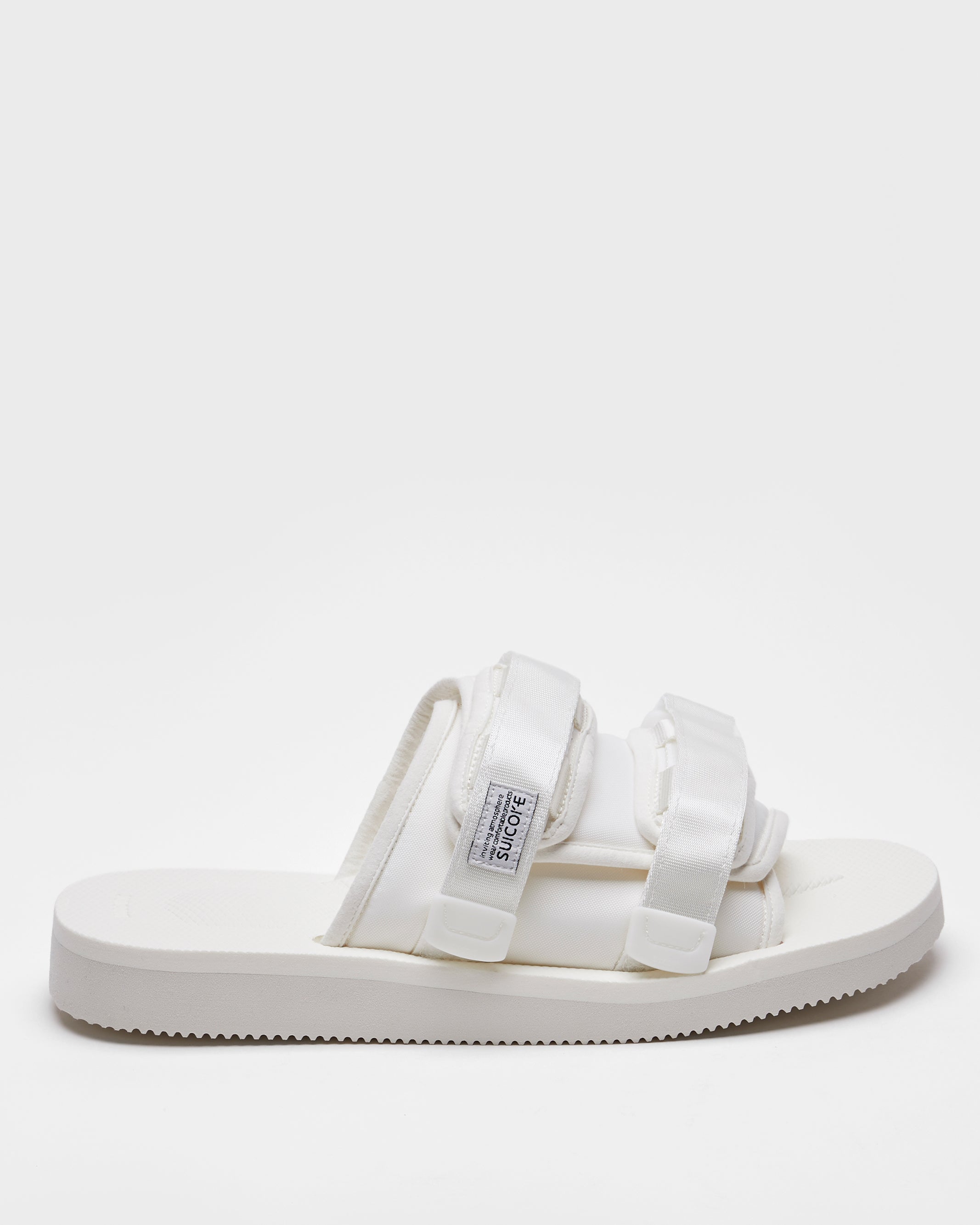 SUICOKE MOTO-Cab slides with white nylon upper, white midsole and sole, straps and logo patch. From Spring/Summer 2022 collection on SUICOKE Official US & Canada Webstore.