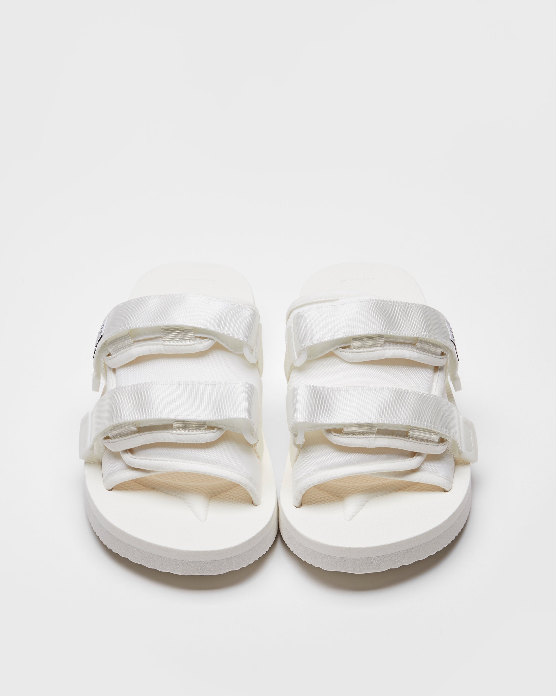 SUICOKE MOTO-Cab slides with white nylon upper, white midsole and sole, straps and logo patch. From Spring/Summer 2022 collection on SUICOKE Official US & Canada Webstore.