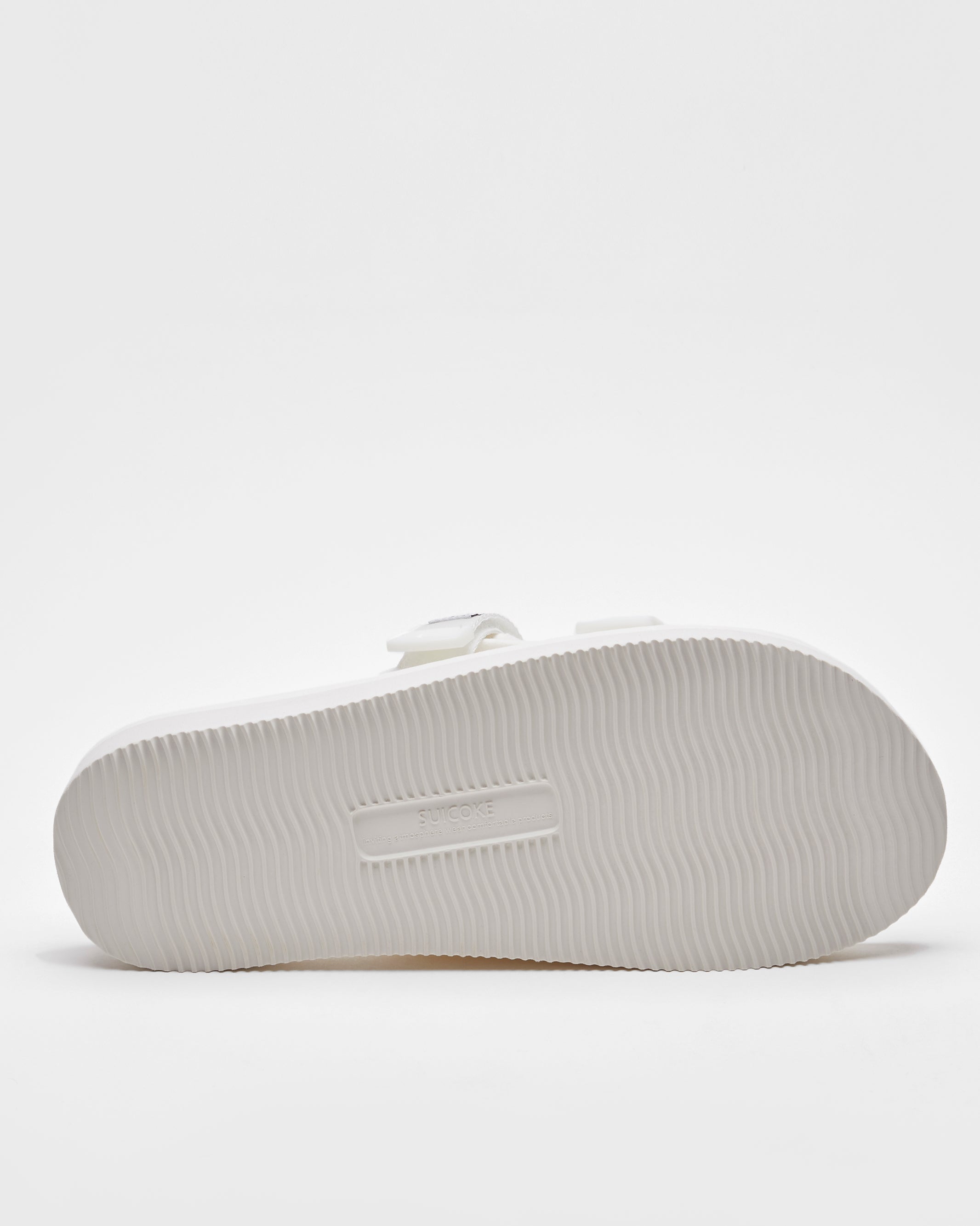 SUICOKE MOTO-Cab slides with white nylon upper, white midsole and sole, straps and logo patch. From Spring/Summer 2022 collection on SUICOKE Official US & Canada Webstore.