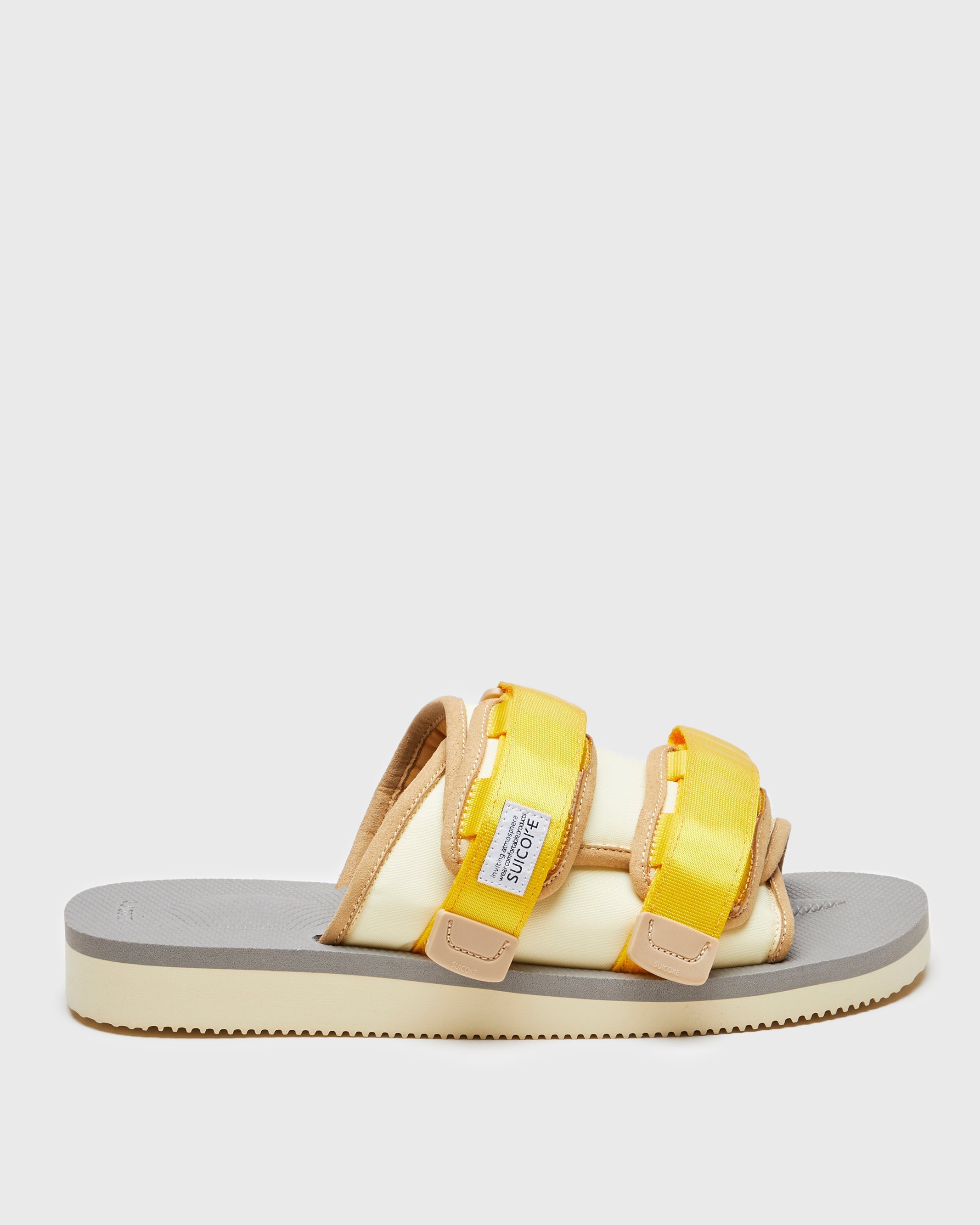 SUICOKE MOTO-Cab slides with yellow & beige nylon upper, yellow & beige midsole and sole, straps and logo patch. From Spring/Summer 2023 collection on SUICOKE Official US & Canada Webstore. OG-056CAB YELLOW X BEIGE