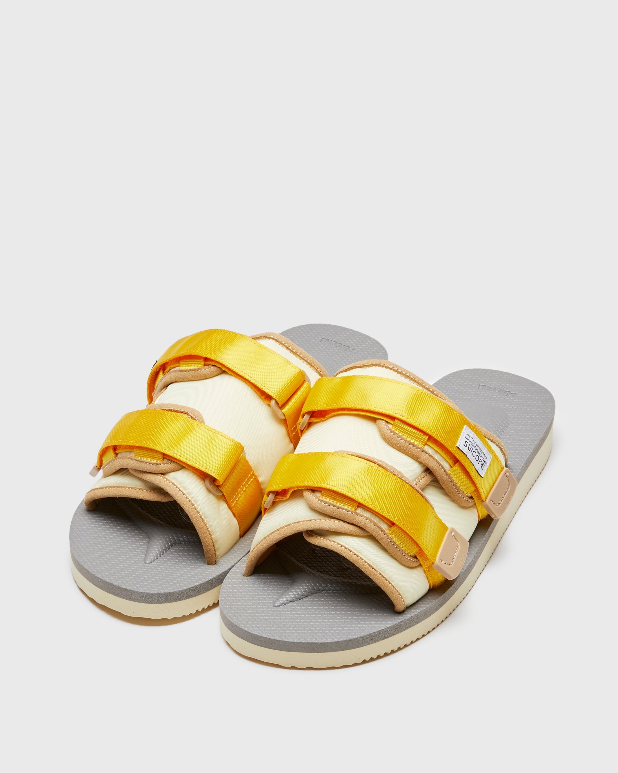 SUICOKE MOTO-Cab slides with yellow & beige nylon upper, yellow & beige midsole and sole, straps and logo patch. From Spring/Summer 2023 collection on SUICOKE Official US & Canada Webstore. OG-056CAB YELLOW X BEIGE