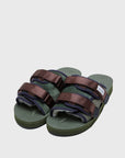 SUICOKE MOTO-Mab suede slides with green midsole and sole, green suede upper and shearling inside with navy piping and brown nylon straps with a logo patch. From Fall/Winter 2021 collection on SUICOKE Official US & Canada Webstore.