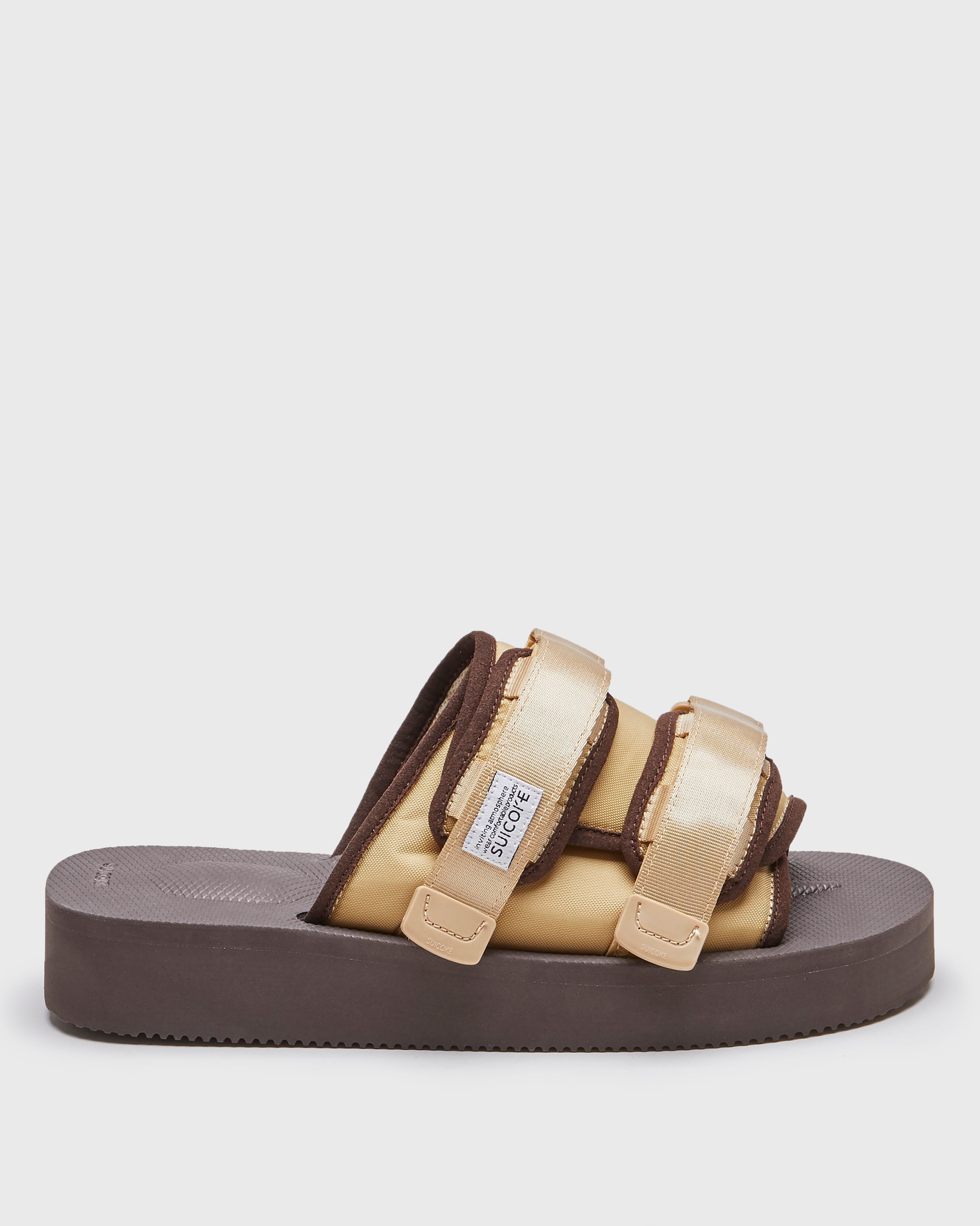 SUICOKE MOTO-PO slides with brown & sand nylon upper, brown & sand midsole and sole, strap and logo patch. From Spring/Summer 2023 collection on SUICOKE Official US & Canada Webstore. OG-056PO BROWN X SAND