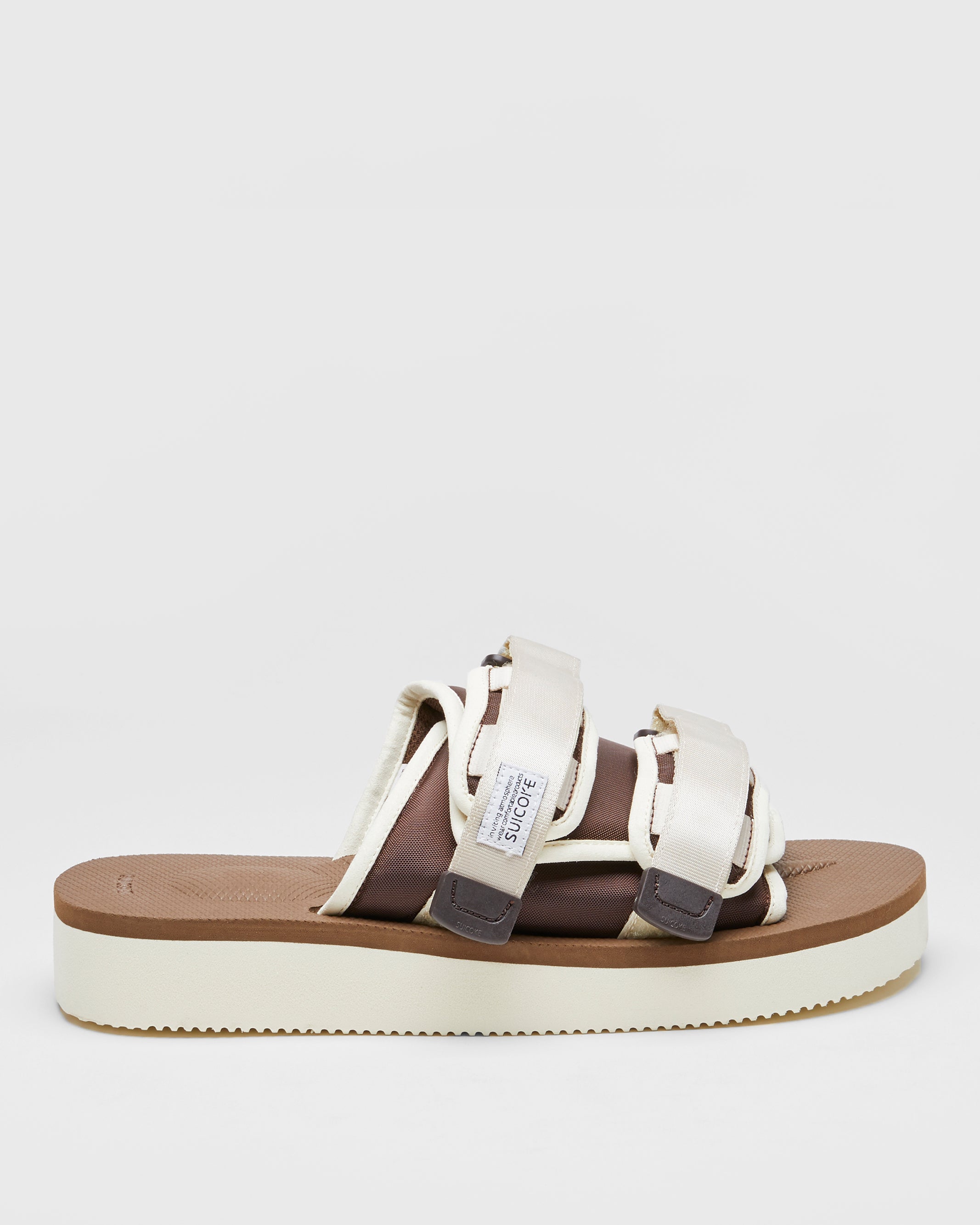 SUICOKE MOTO-PO slides with ivory & brown nylon upper, ivory & brown midsole and sole, strap and logo patch. From Spring/Summer 2023 collection on SUICOKE Official US & Canada Webstore. OG-056PO IVORY X BROWN