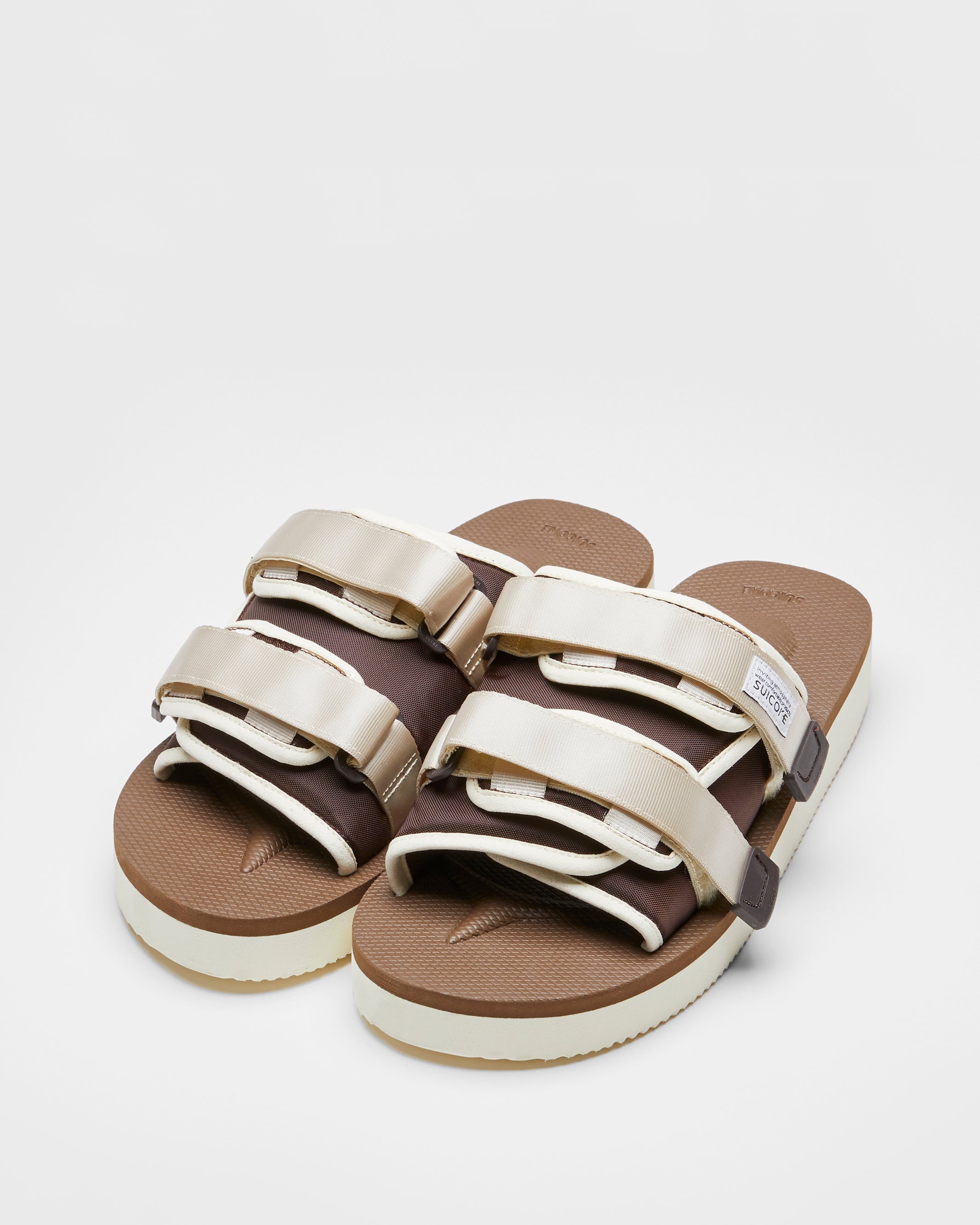 SUICOKE MOTO-PO slides with ivory & brown nylon upper, ivory & brown midsole and sole, strap and logo patch. From Spring/Summer 2023 collection on SUICOKE Official US & Canada Webstore. OG-056PO IVORY X BROWN