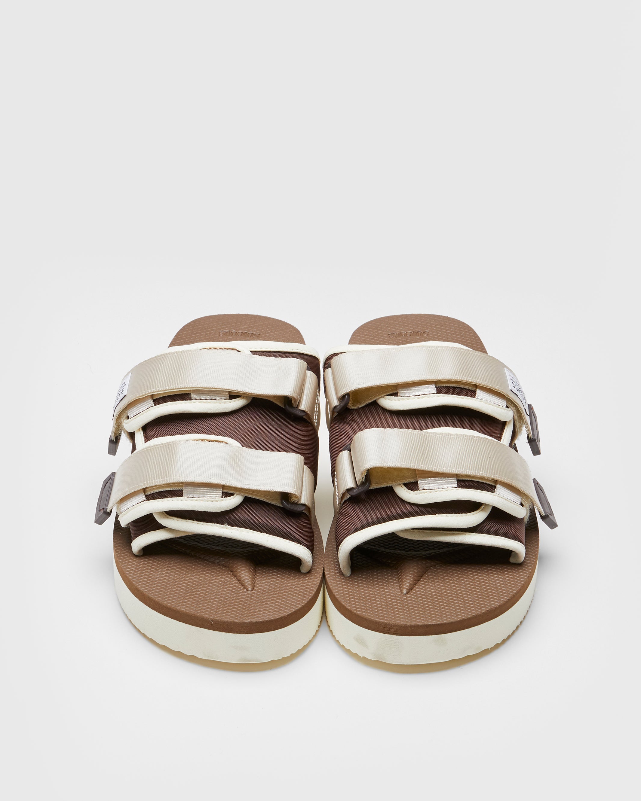 SUICOKE MOTO-PO slides with ivory & brown nylon upper, ivory & brown midsole and sole, strap and logo patch. From Spring/Summer 2023 collection on SUICOKE Official US & Canada Webstore. OG-056PO IVORY X BROWN