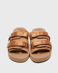 SUICOKE MOTO-Vhl slides with camel colored calf hair upper, camel colored midsole and sole, straps with logo patch and gold logoed tabs. From Fall/Winter 2021 collection on SUICOKE Official US & Canada Webstore.