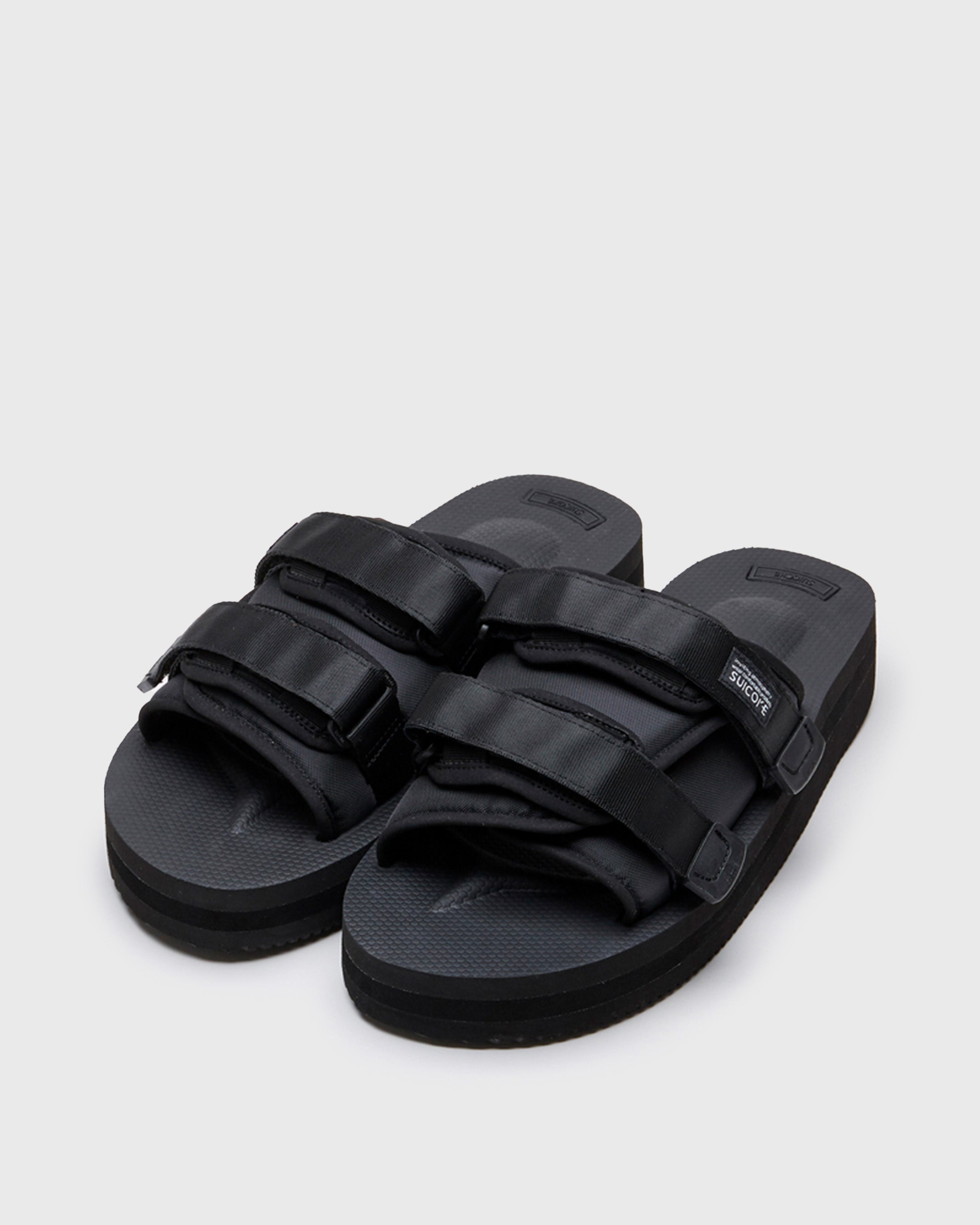 SUICOKE MOTO-VPO slides with black nylon upper, black midsole and sole, straps and logo patch. From Spring/Summer 2022 collection on SUICOKE Official US & Canada Webstore.