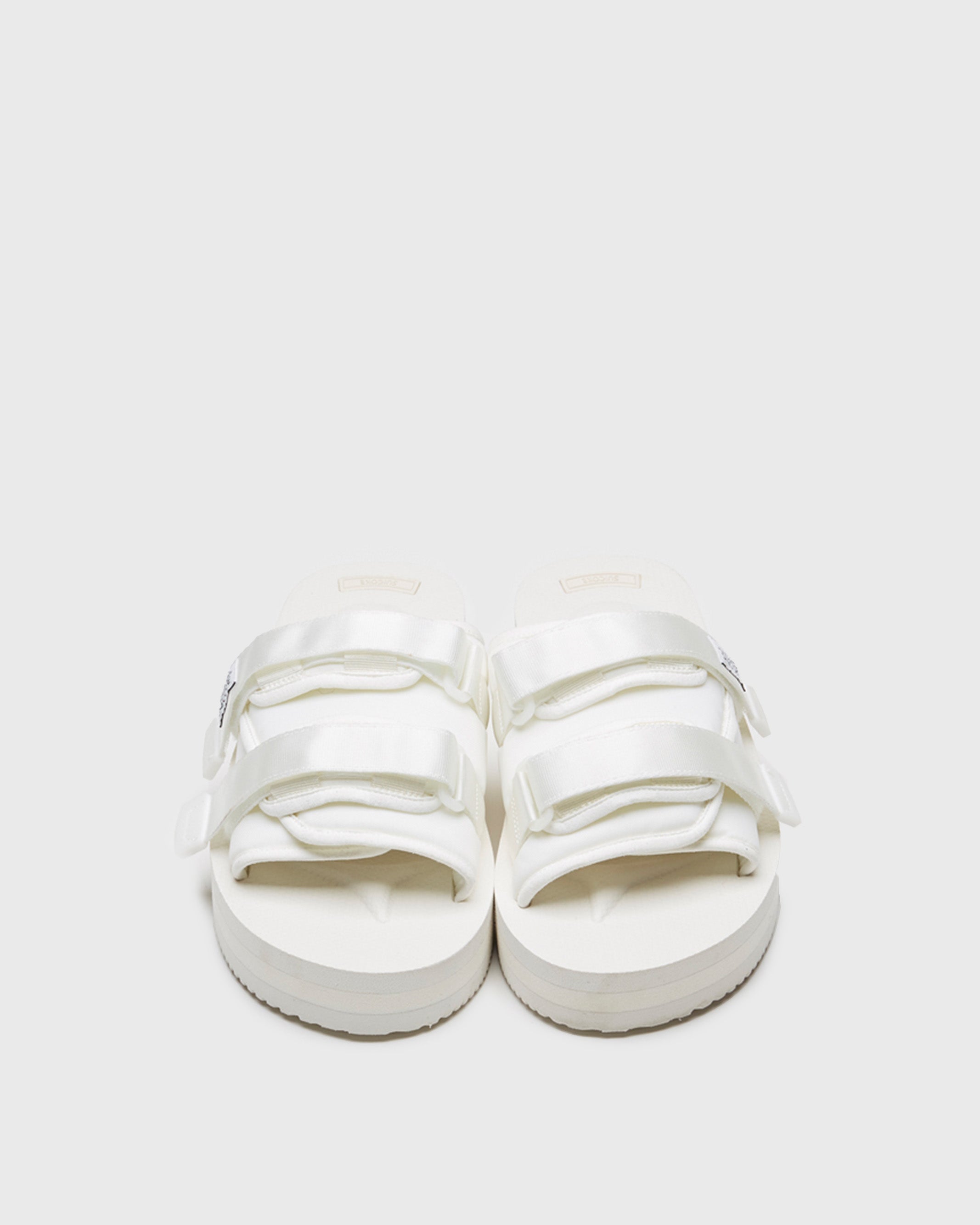 SUICOKE MOTO-VPO slides with white nylon upper, white midsole and sole, straps and logo patch. From Spring/Summer 2022 collection on SUICOKE Official US & Canada Webstore.