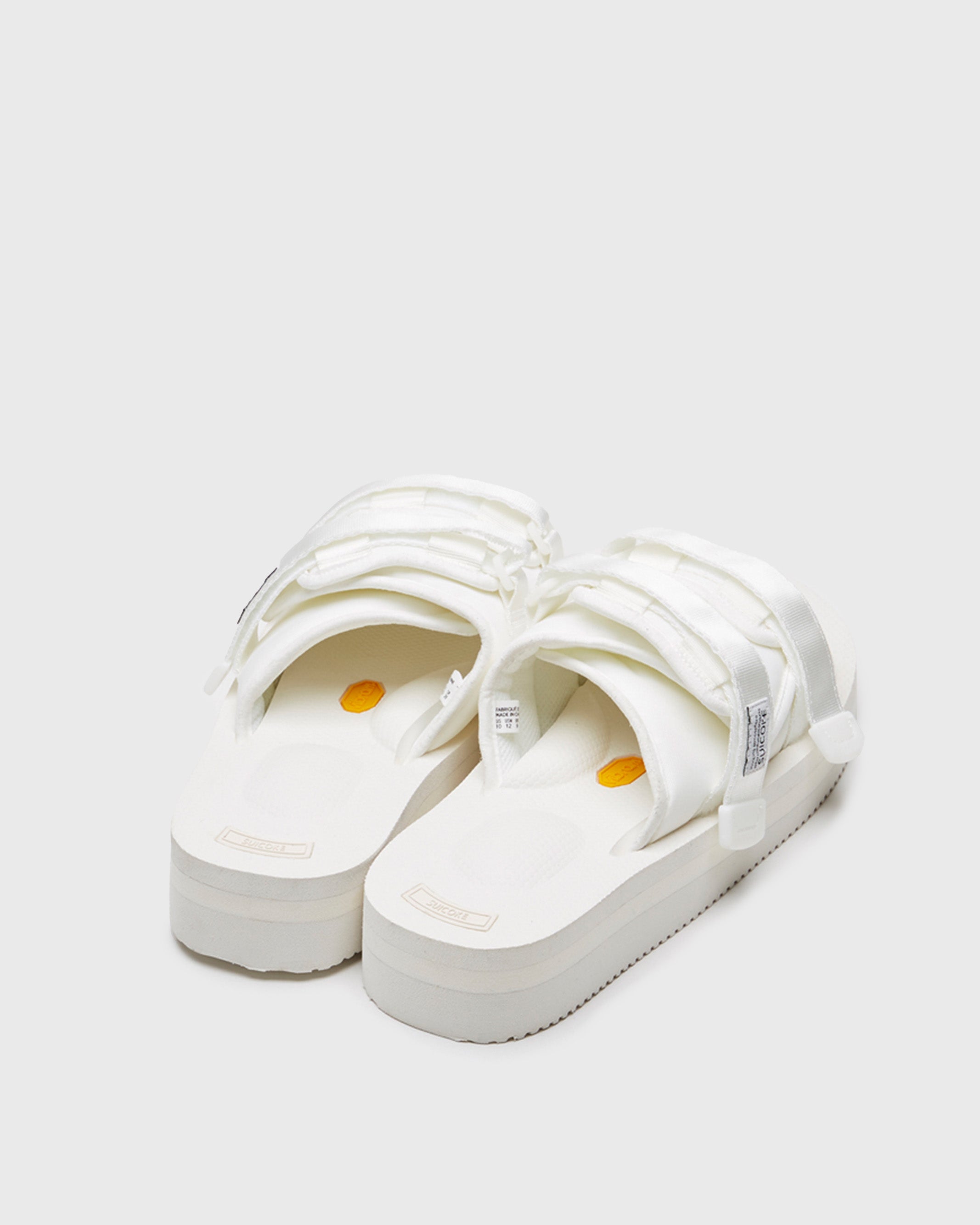 SUICOKE MOTO-VPO slides with white nylon upper, white midsole and sole, straps and logo patch. From Spring/Summer 2022 collection on SUICOKE Official US & Canada Webstore.