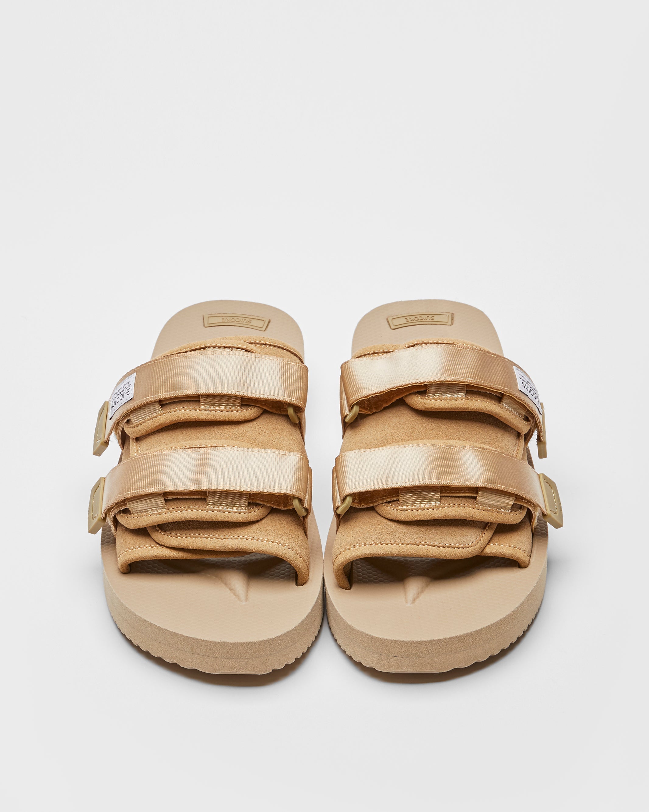 SUICOKE MOTO-VS slides with beige cow suede upper, beige midsole and sole, straps and logo patch. From Spring/Summer 2022 collection on SUICOKE Official US & Canada Webstore.