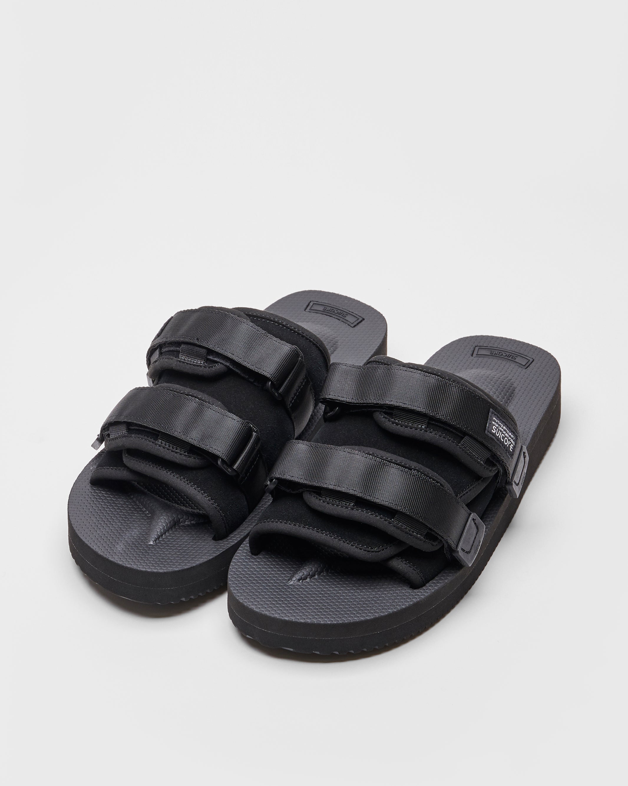 SUICOKE MOTO-VS slides with black cow suede upper, black midsole and sole, straps and logo patch. From Spring/Summer 2022 collection on SUICOKE Official US & Canada Webstore.