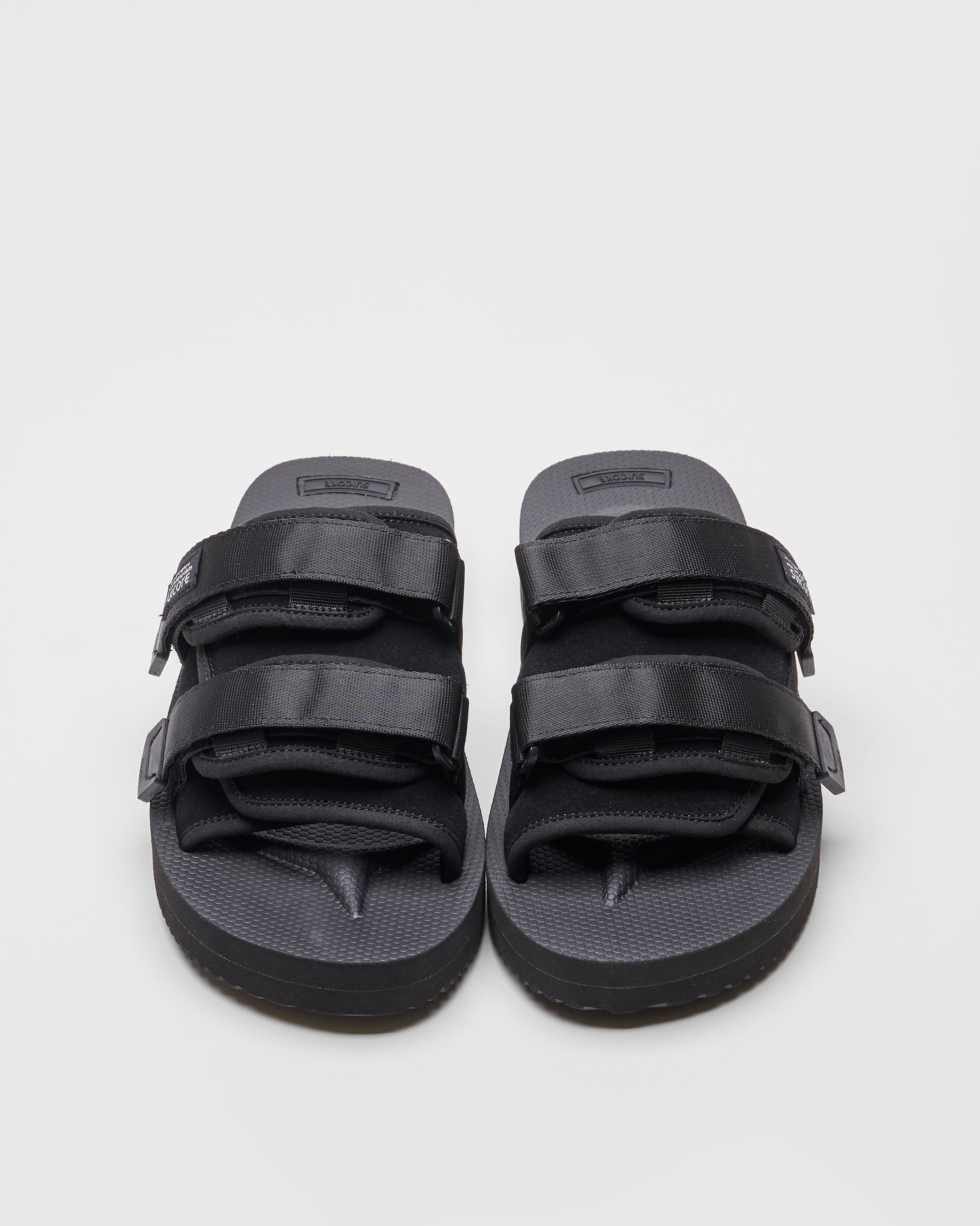 SUICOKE MOTO-VS slides with black cow suede upper, black midsole and sole, straps and logo patch. From Spring/Summer 2022 collection on SUICOKE Official US & Canada Webstore.