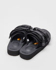 SUICOKE MOTO-VS slides with black cow suede upper, black midsole and sole, straps and logo patch. From Spring/Summer 2022 collection on SUICOKE Official US & Canada Webstore.