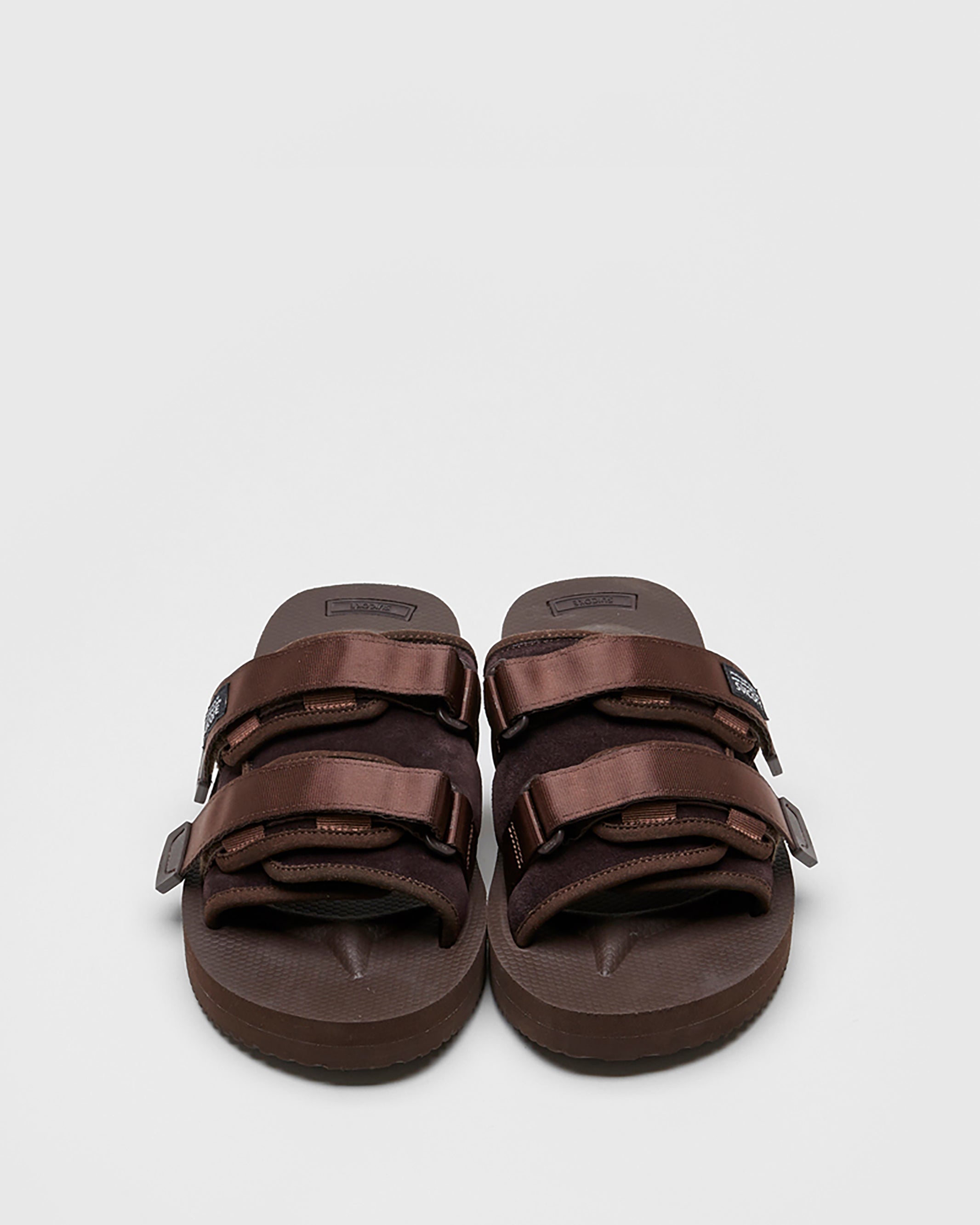 SUICOKE MOTO-VS slides with brown cow suede upper, brown midsole and sole, straps and logo patch. From Spring/Summer 2022 collection on SUICOKE Official US & Canada Webstore.