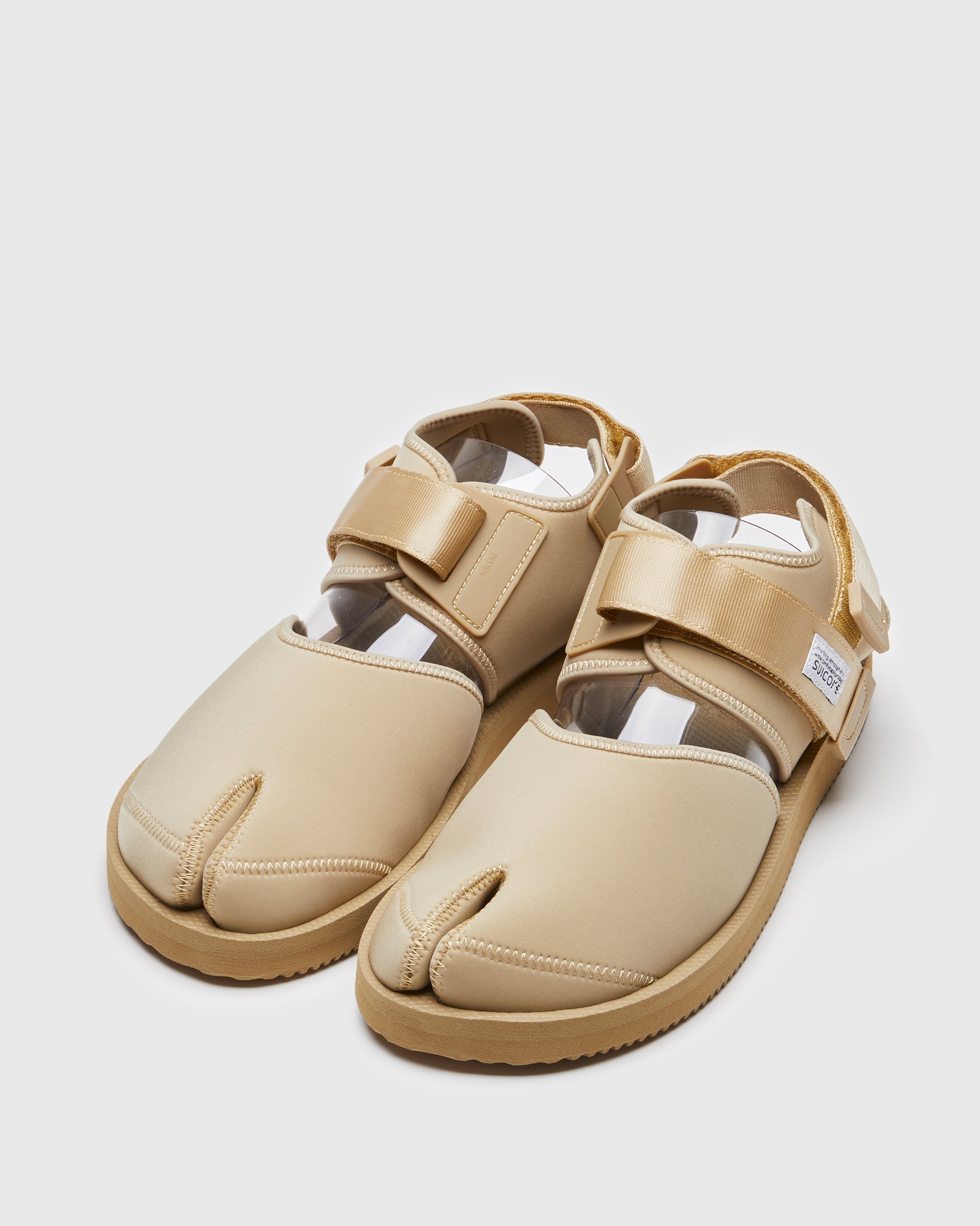 SUICOKE BITA-V shoes with beige nylon upper, beige midsole and sole, straps and logo patch. From Spring/Summer 2022 collection on SUICOKE Official US & Canada Webstore.