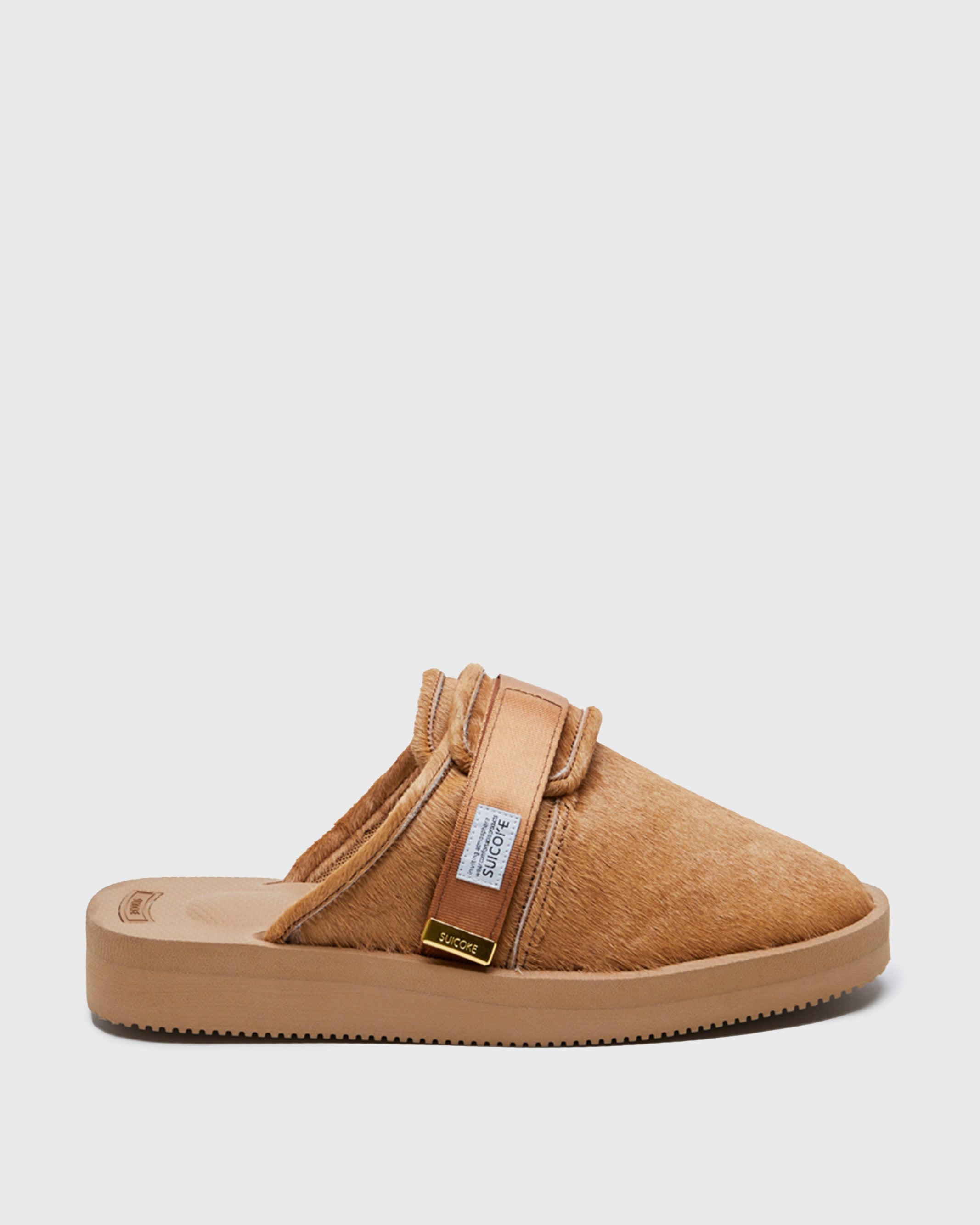 SUICOKE ZAVO-Vhl closed toe slides with camel colored calf hair upper, midsole and sole, straps and gold tabs with logo patch and piping on SUICOKE Official US & Canada Webstore.