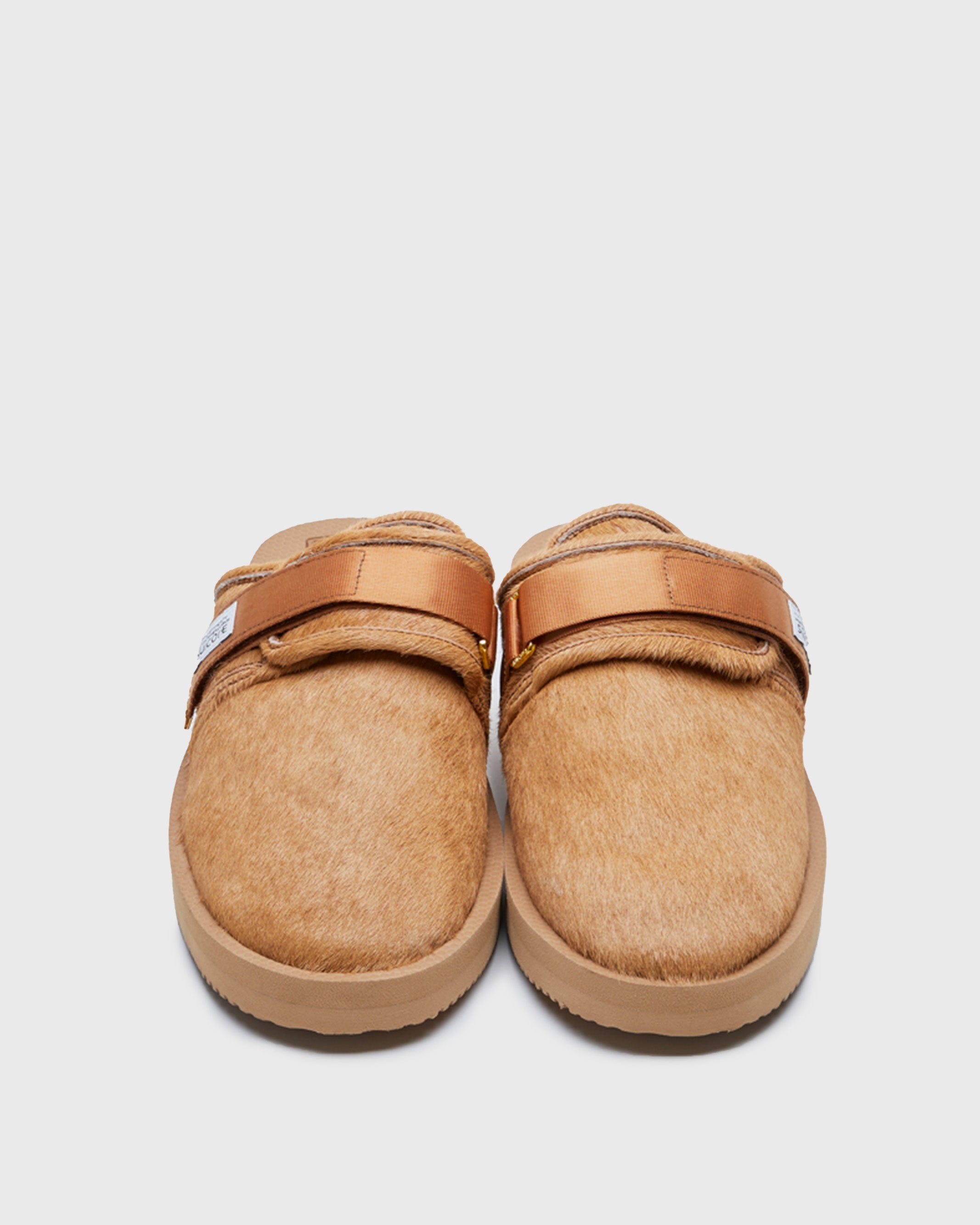 SUICOKE ZAVO-Vhl closed toe slides with camel colored calf hair upper, midsole and sole, straps and gold tabs with logo patch and piping on SUICOKE Official US & Canada Webstore.